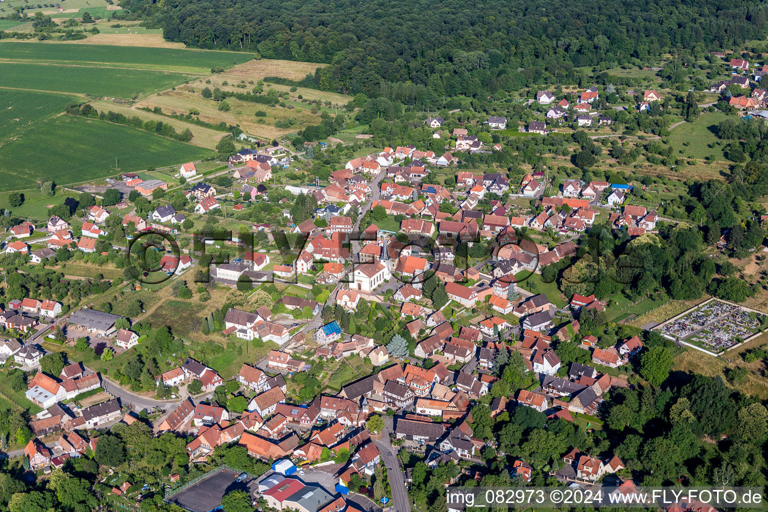 Aerial view of Village - view on the edge of agricultural fields and farmland in Lampertsloch in Grand Est, France