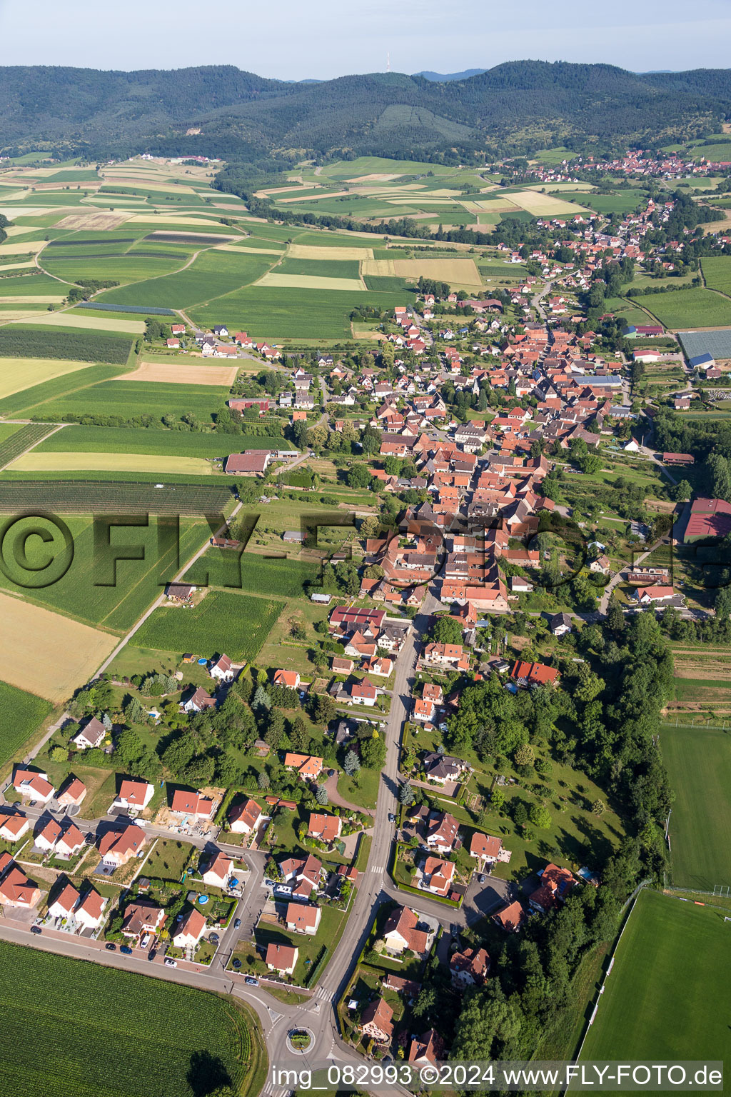 Aerial view of Village - view on the edge of agricultural fields and farmland in Steinseltz in Grand Est, France