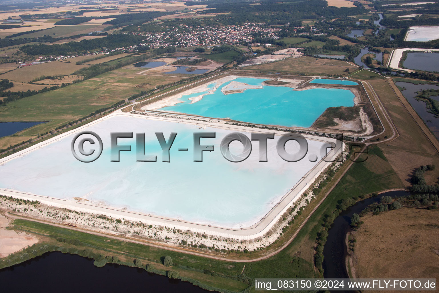 Brown - white salt pans for salt extraction in RosiA?res-aux-Salines in Alsace-Champagne-Ardenne-Lorraine, France from the plane