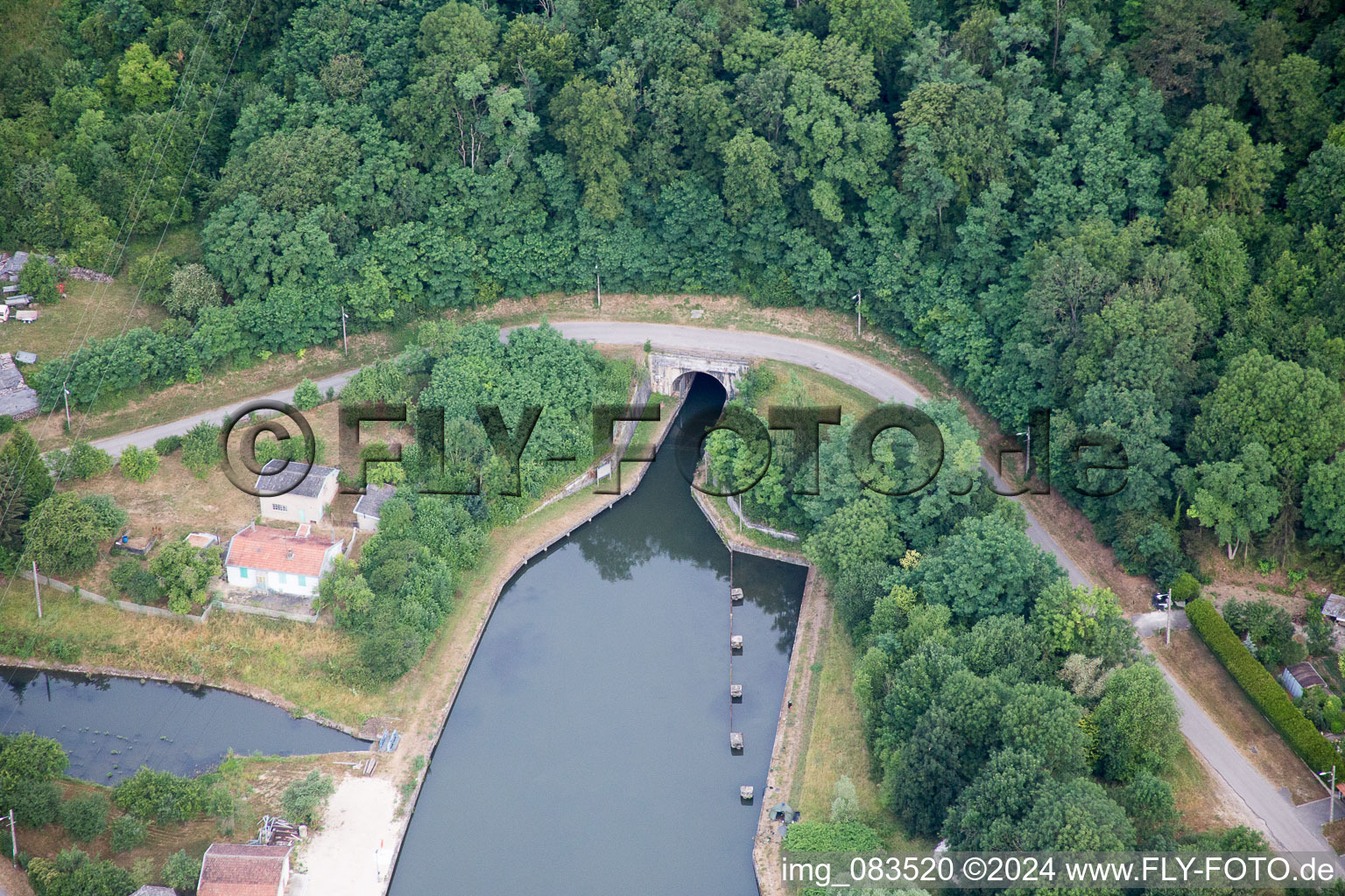 Aerial view of Channel flow through tunnel and river banks of the waterway shipping Rhine to Marne channel in Foug in Grand Est, France