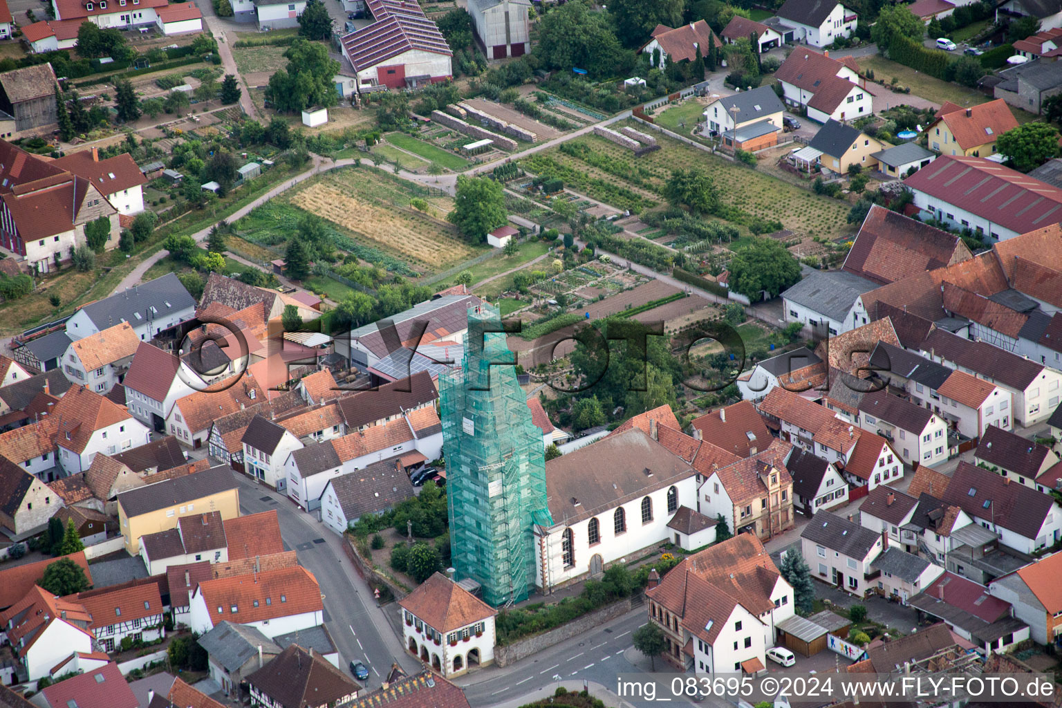 Oblique view of Catholic church scaffolded by Leidner GmbH Gerüstbau, Landau in the district Ottersheim in Ottersheim bei Landau in the state Rhineland-Palatinate, Germany