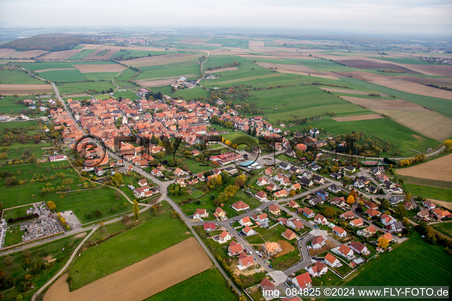 Village - view on the edge of agricultural fields and farmland in Uhrwiller in Grand Est, France