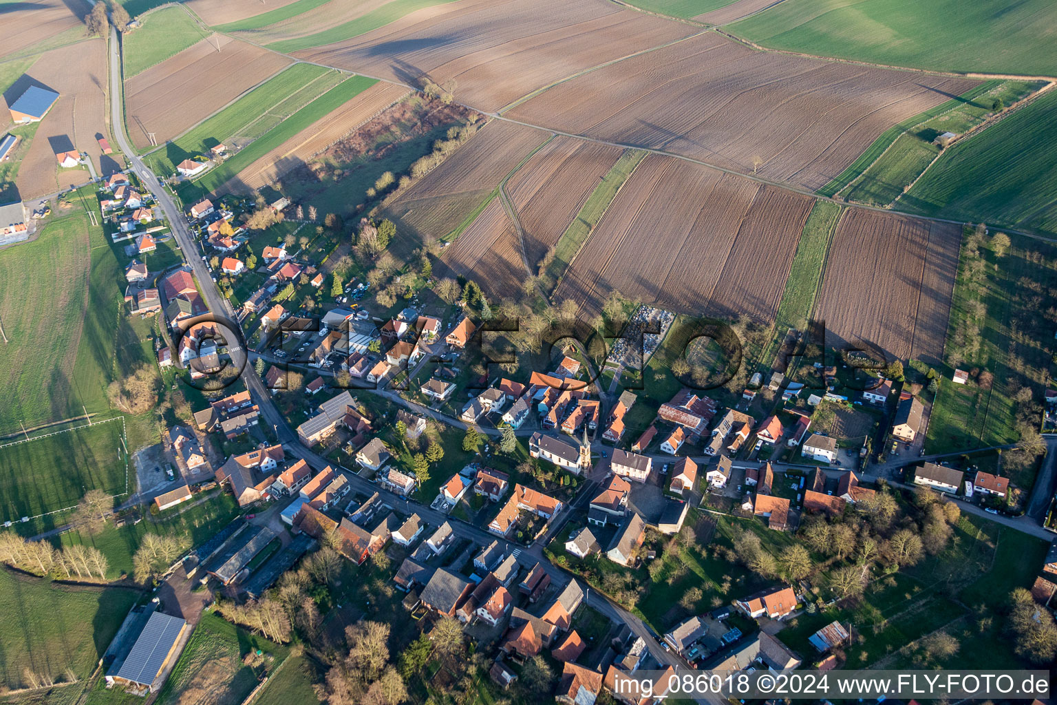 Village - view on the edge of agricultural fields and farmland in Siegen in Grand Est, France