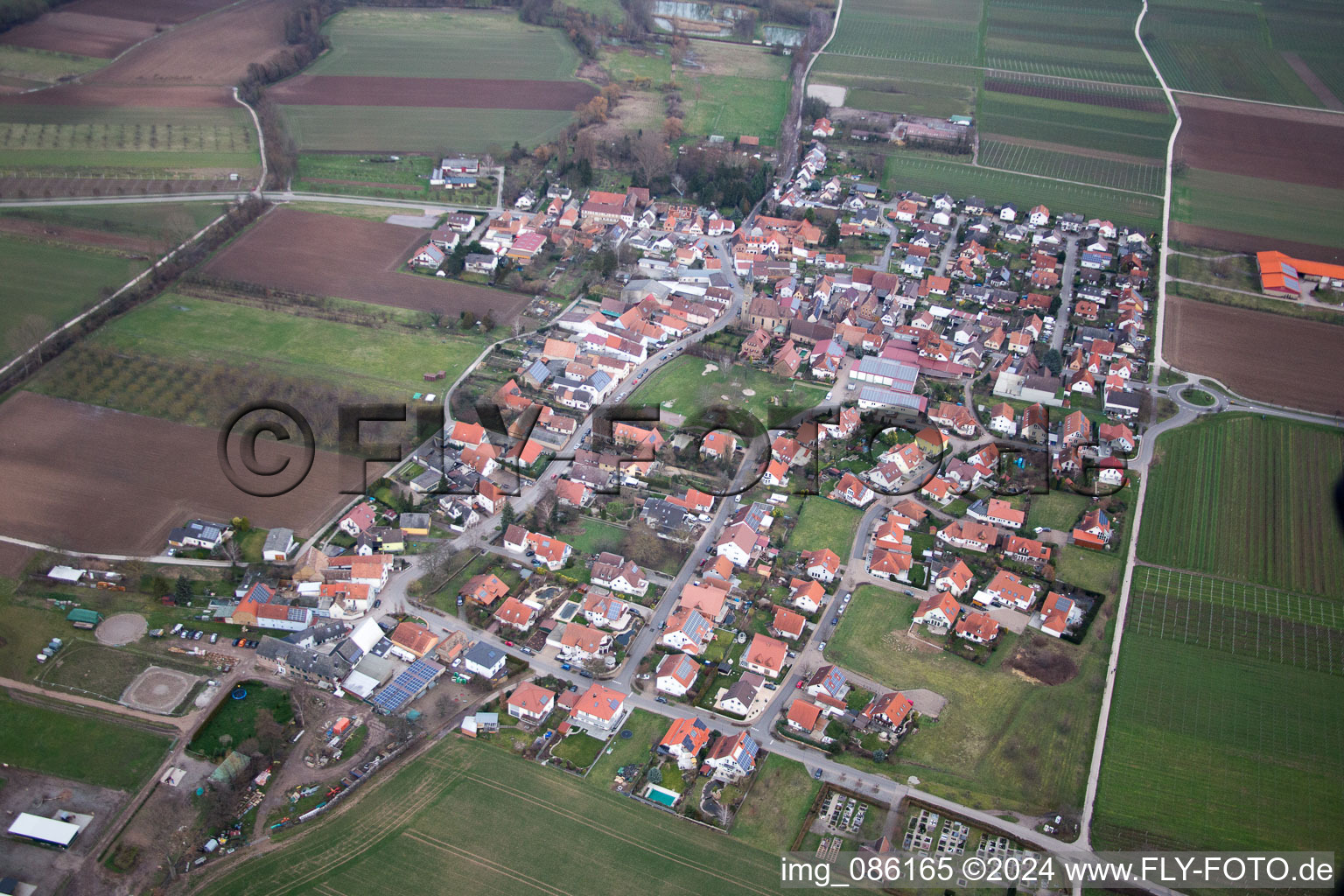 Aerial view of Village - view on the edge of agricultural fields and farmland in Grossfischlingen in the state Rhineland-Palatinate, Germany