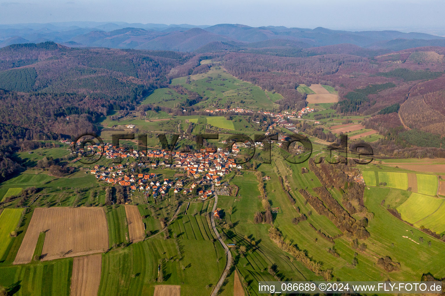 Aerial view of Village - view on the edge of agricultural fields and farmland in Wingen in Grand Est, France