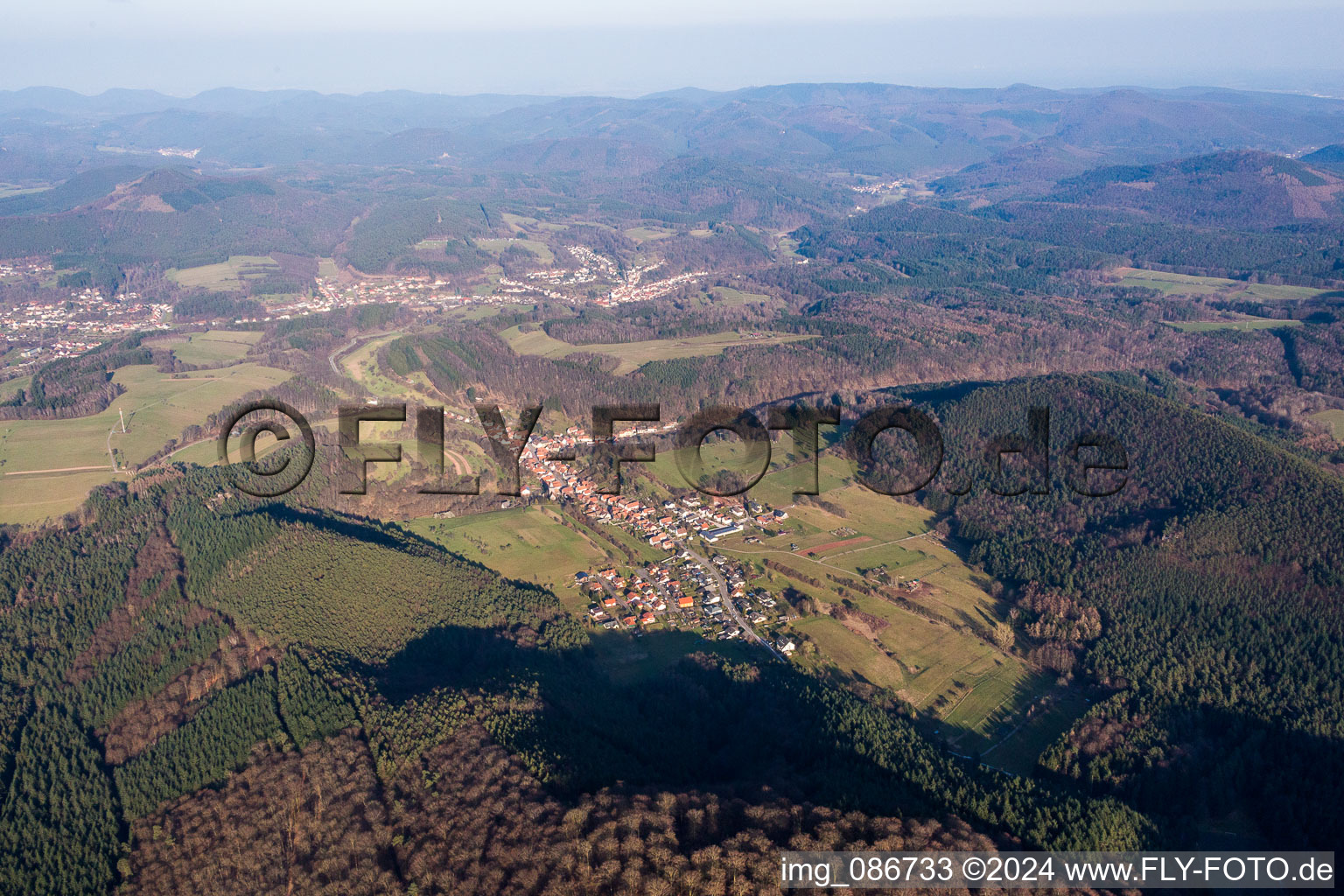 Village - view on the edge of agricultural fields and farmland in Rumbach in the state Rhineland-Palatinate, Germany