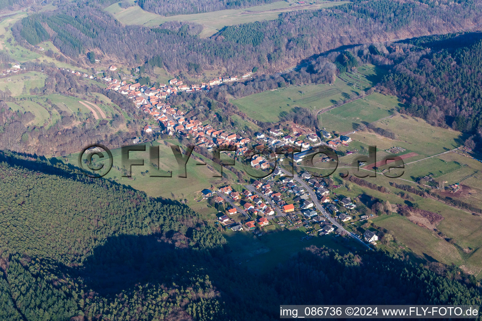 Aerial view of Village - view on the edge of agricultural fields and farmland in Rumbach in the state Rhineland-Palatinate, Germany