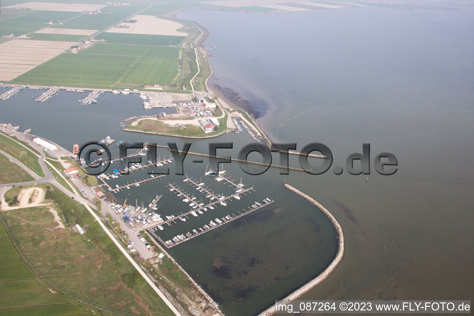 Aerial view of Pleasure boat marina with docks and moorings on the shore area der Adria in Goro in Emilia-Romagna, Italy