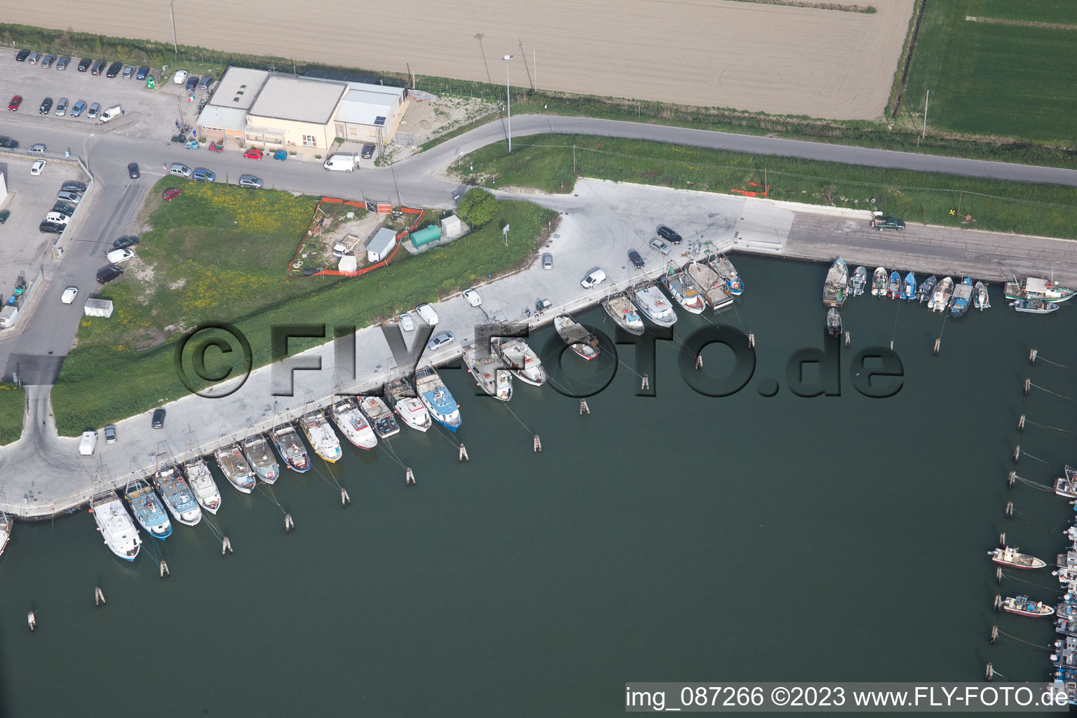 Oblique view of Pleasure boat marina with docks and moorings on the shore area der Adria in Goro in Emilia-Romagna, Italy