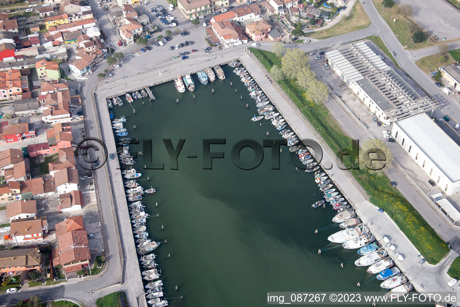 Pleasure boat marina with docks and moorings on the shore area der Adria in Goro in Emilia-Romagna, Italy from above