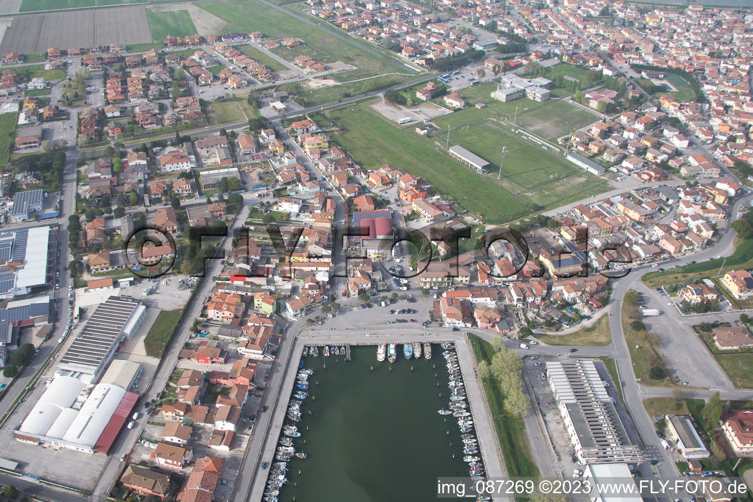 Pleasure boat marina with docks and moorings on the shore area der Adria in Goro in Emilia-Romagna, Italy seen from above