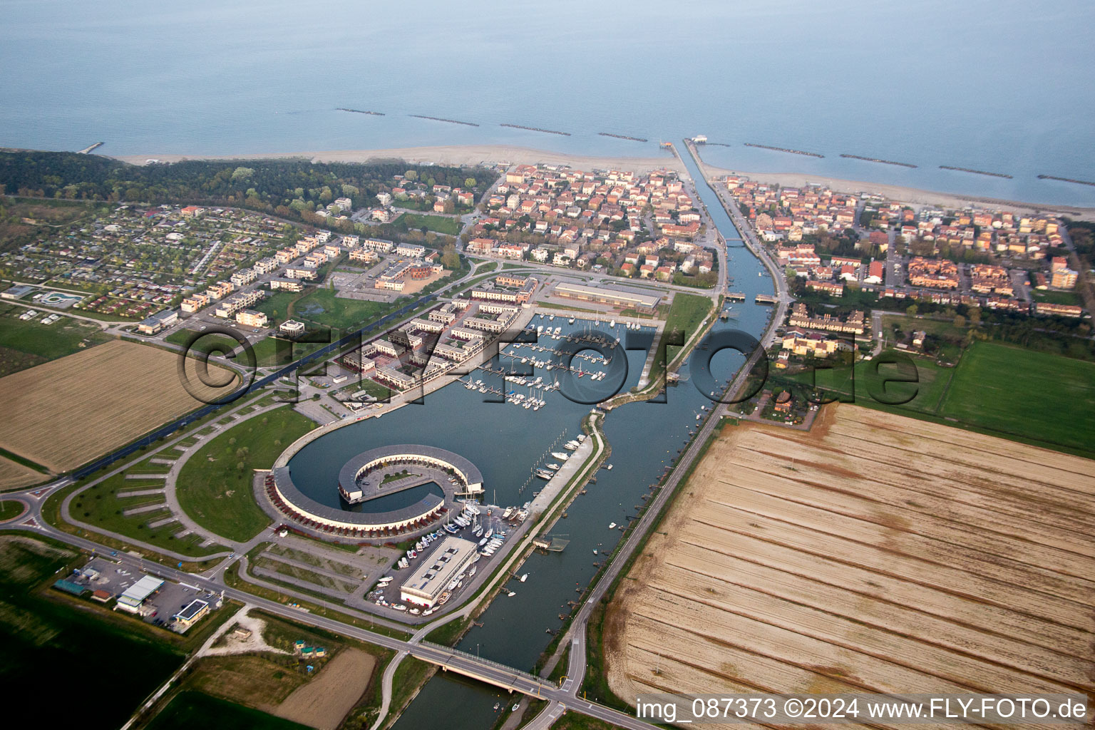 Aerial view of Pleasure boat marina with docks and moorings on the shore area Marina di Porto Reno in Casalborsetti in Emilia-Romagna, Italy