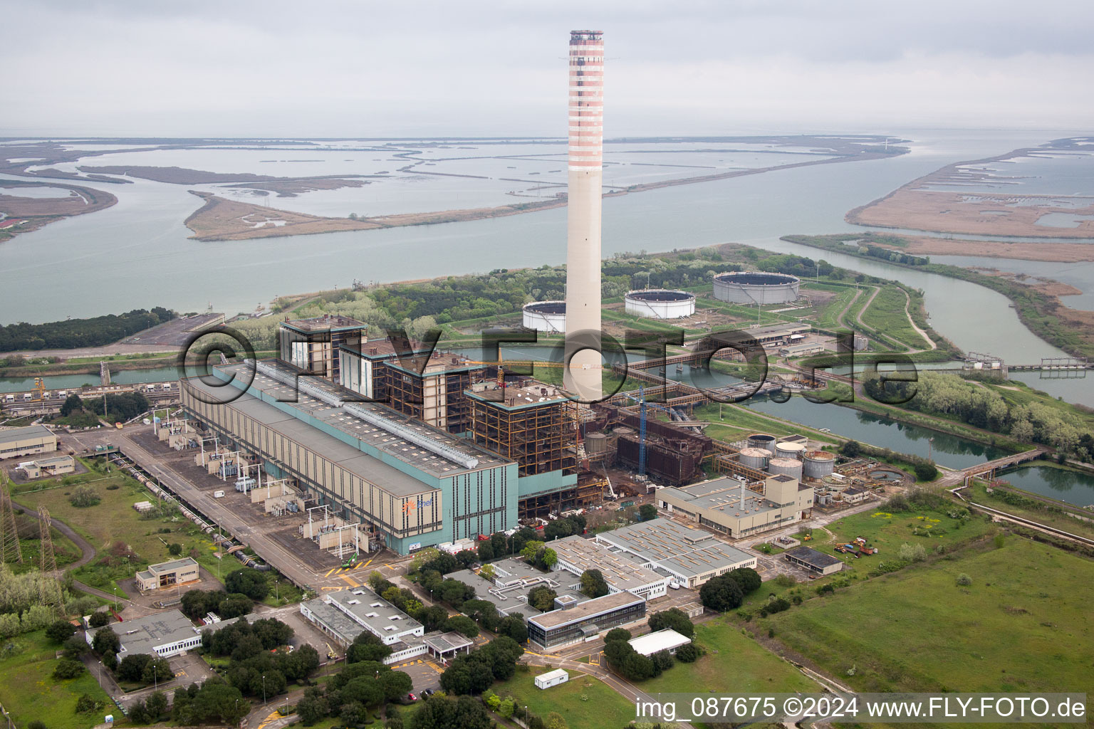 Aerial view of Power plants and exhaust towers of electrical power station at the mouth of river Po in Centrale Enel in Veneto, Italy