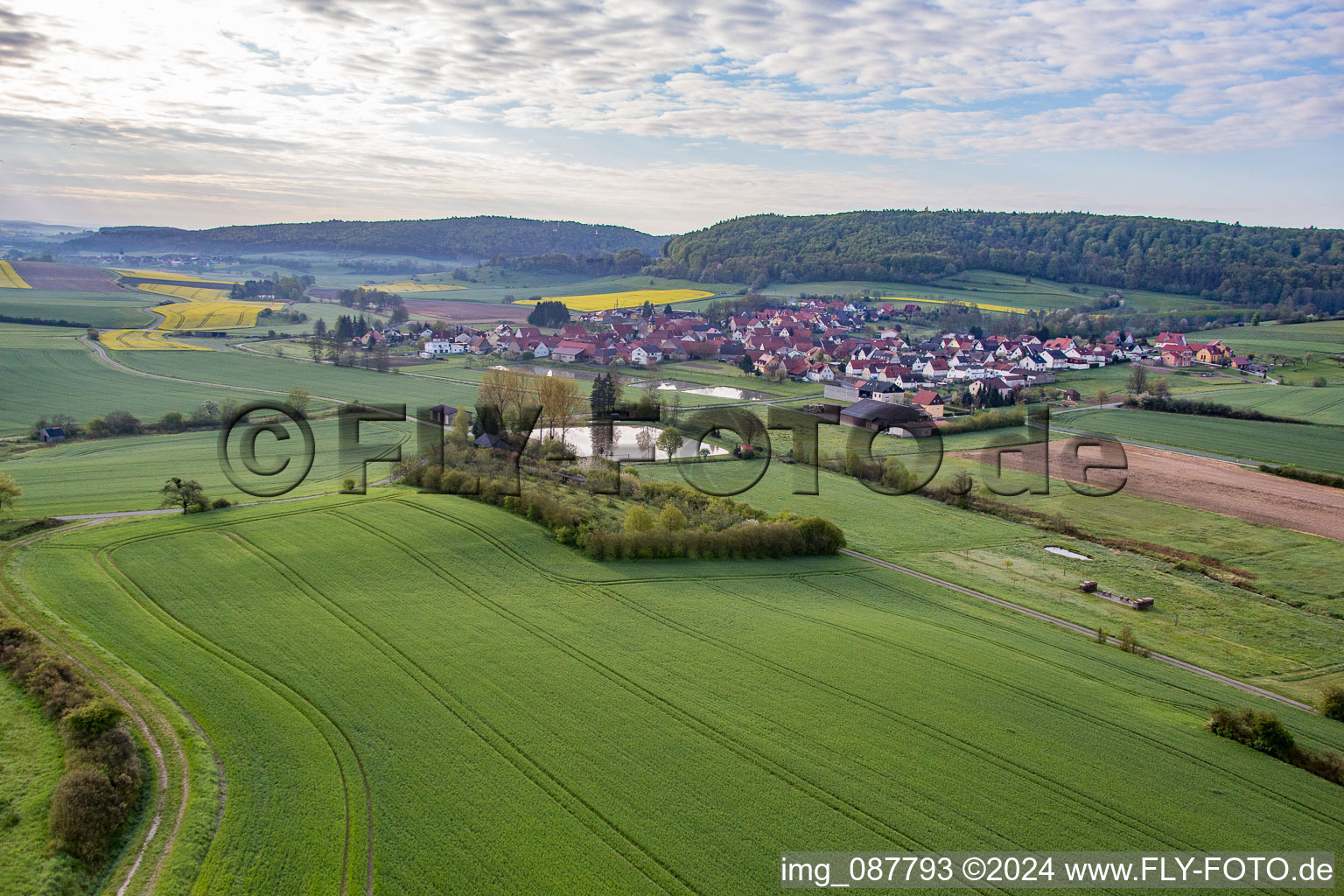 Village - view on the edge of agricultural fields and farmland in Rauhenebrach in the state Bavaria, Germany