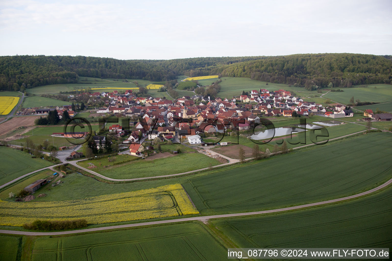 Village - view on the edge of agricultural fields and farmland in Rauhenebrach in the state Bavaria, Germany