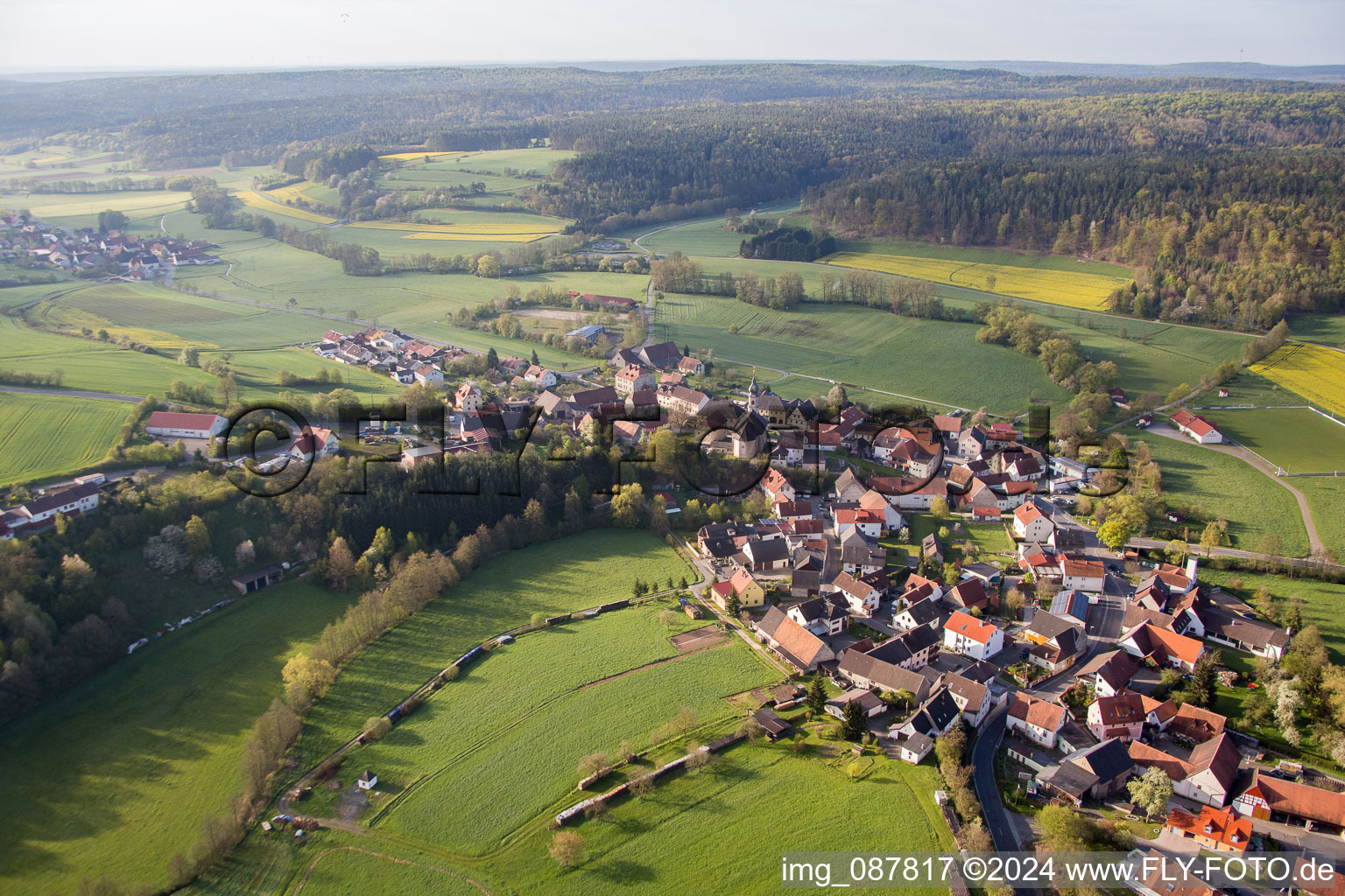 Village - view on the edge of agricultural fields and farmland in Proelsdorf in the state Bavaria, Germany