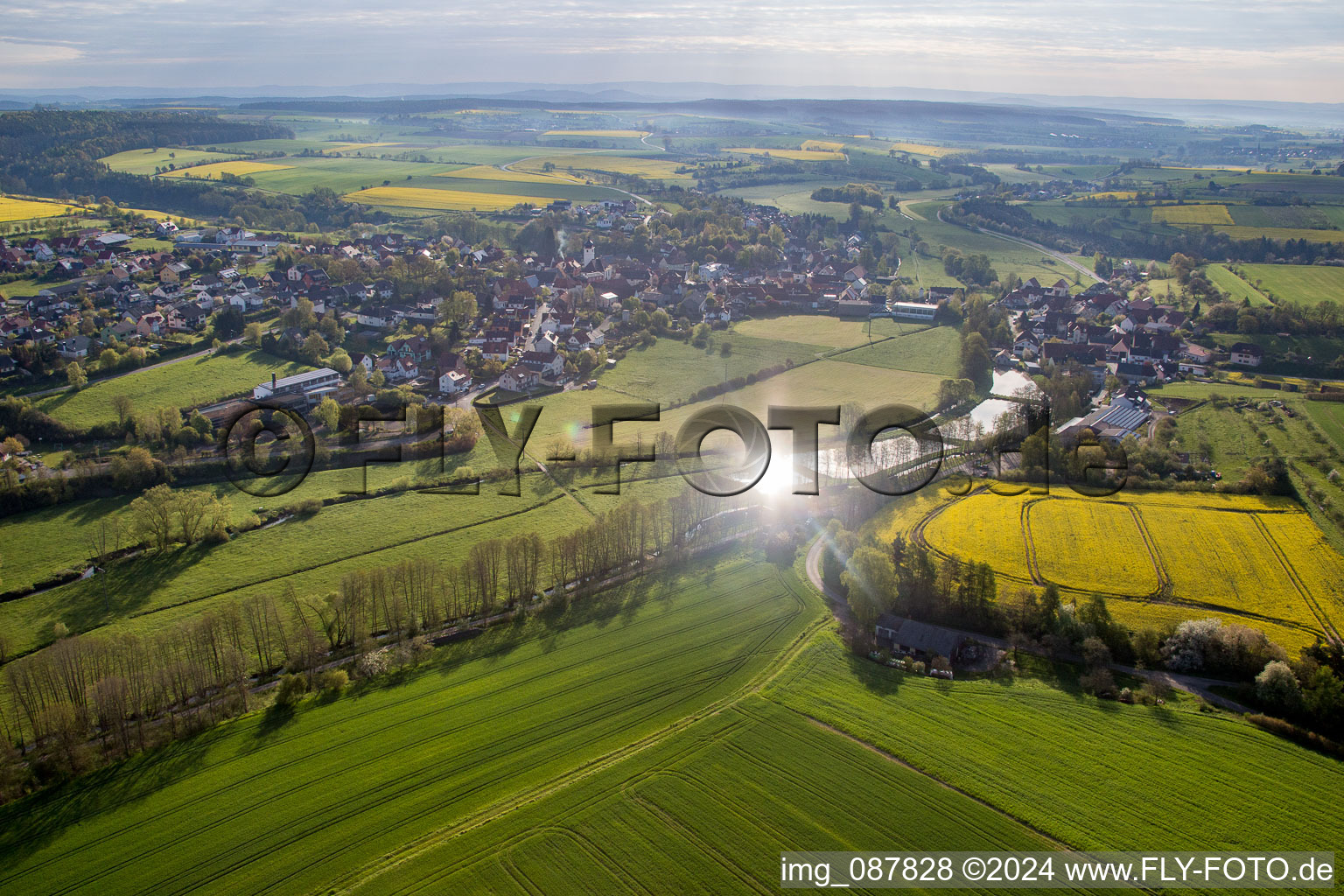 Village - view on the edge of agricultural fields and farmland in Schoenbrunn im Steigerwald in the state Bavaria, Germany