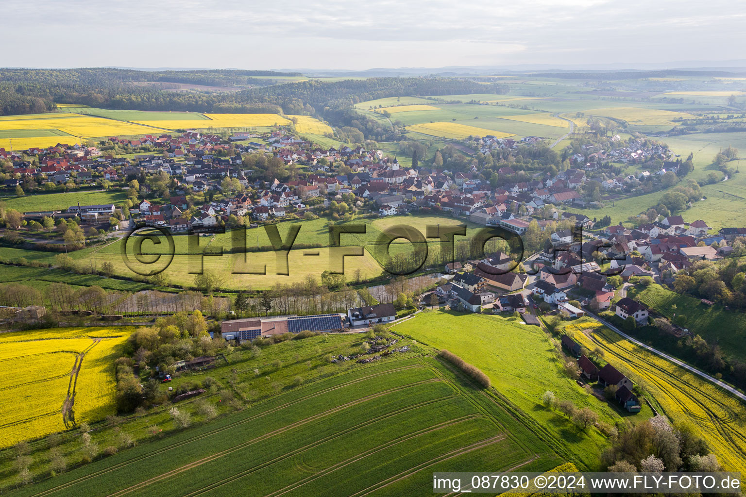 Village - view on the edge of agricultural fields and farmland in Schoenbrunn im Steigerwald in the state Bavaria, Germany