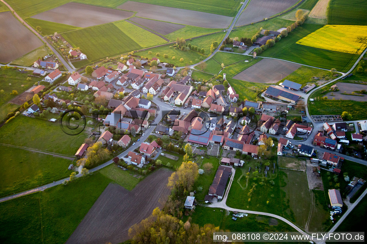 Village - view on the edge of agricultural fields and farmland in the district Jaerkendorf in Prichsenstadt in the state Bavaria, Germany