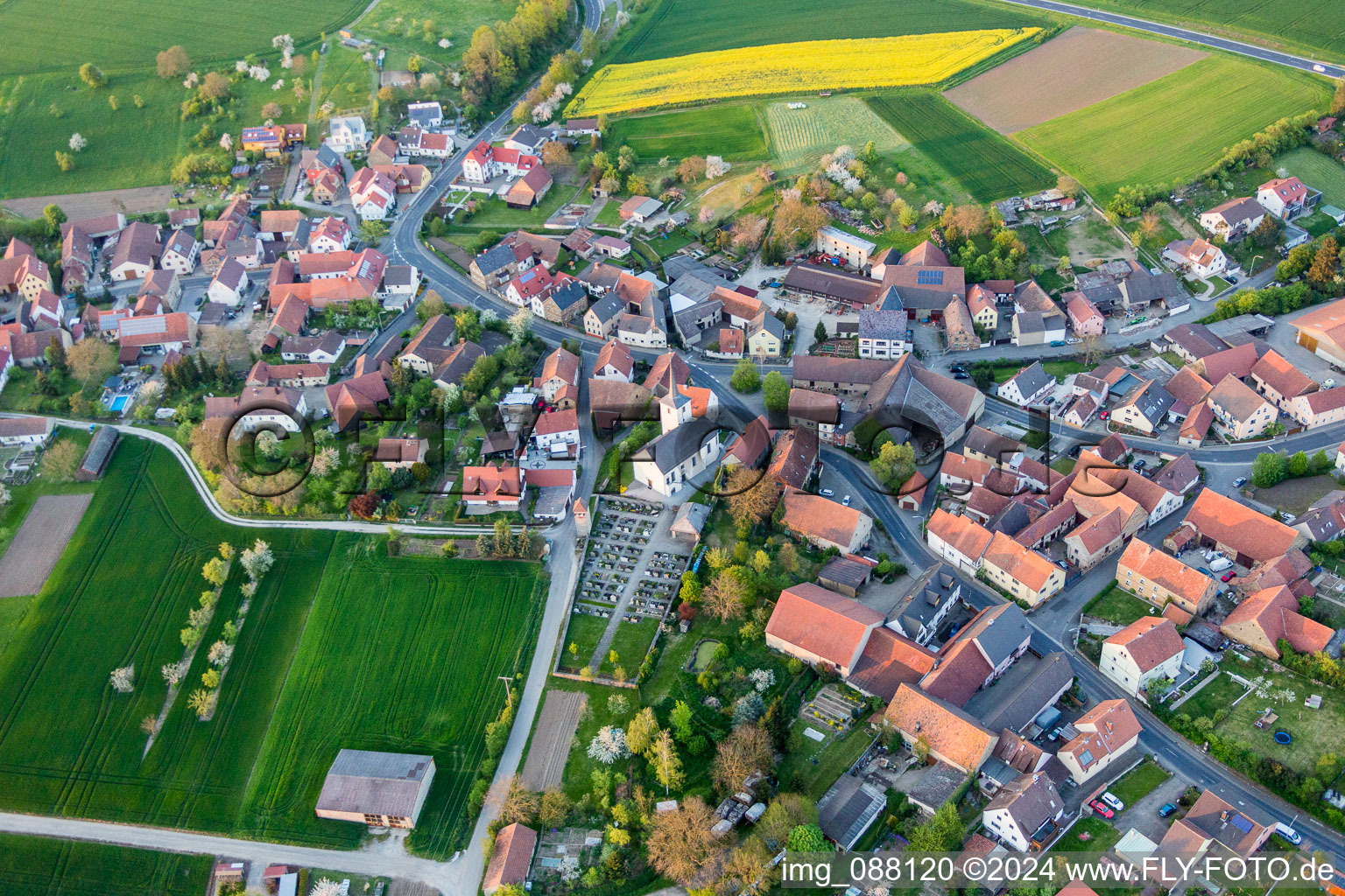 Village - view on the edge of agricultural fields and farmland in Schallfeld in the state Bavaria, Germany