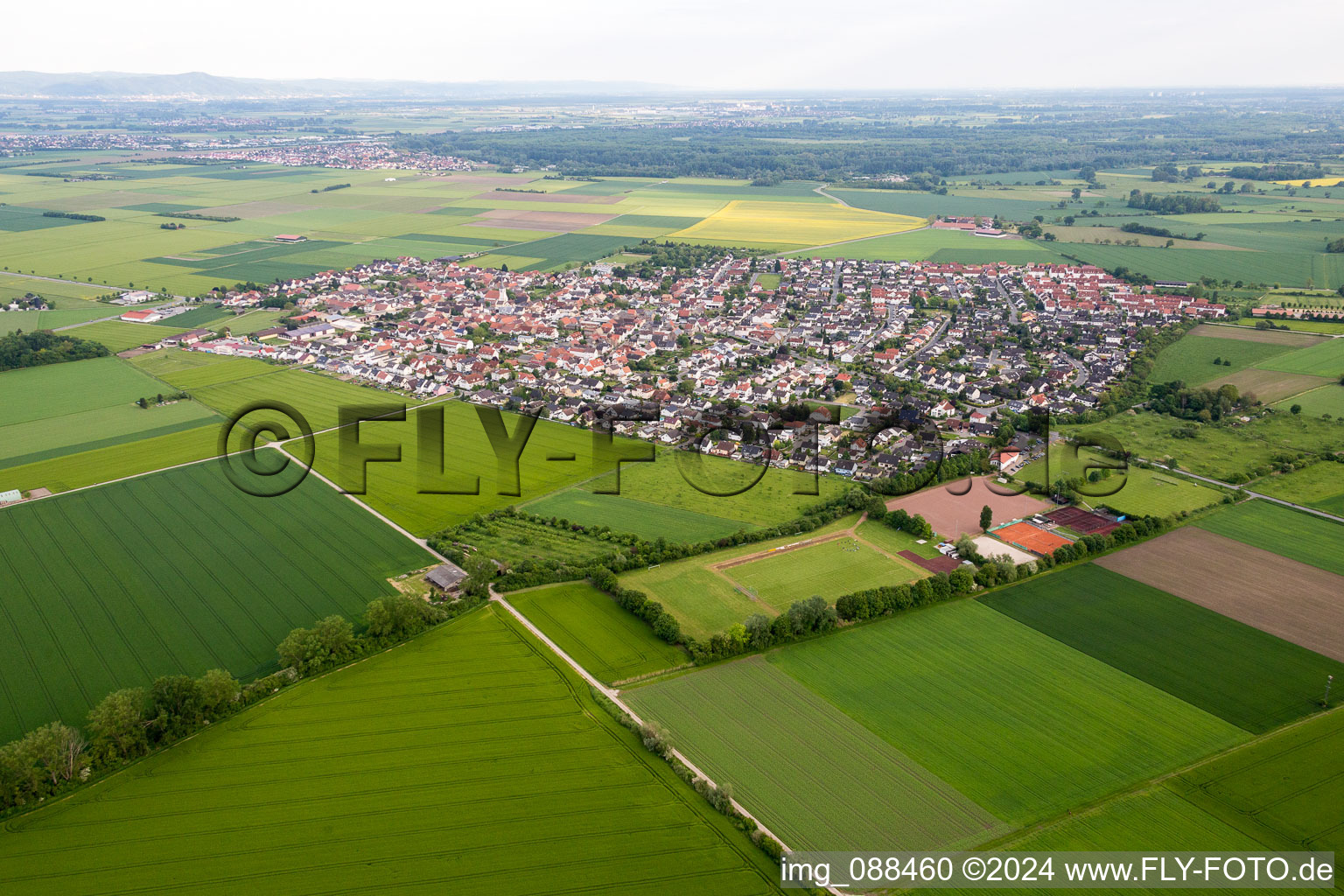 Village - view on the edge of agricultural fields and farmland in the district Leeheim in Riedstadt in the state Hesse, Germany