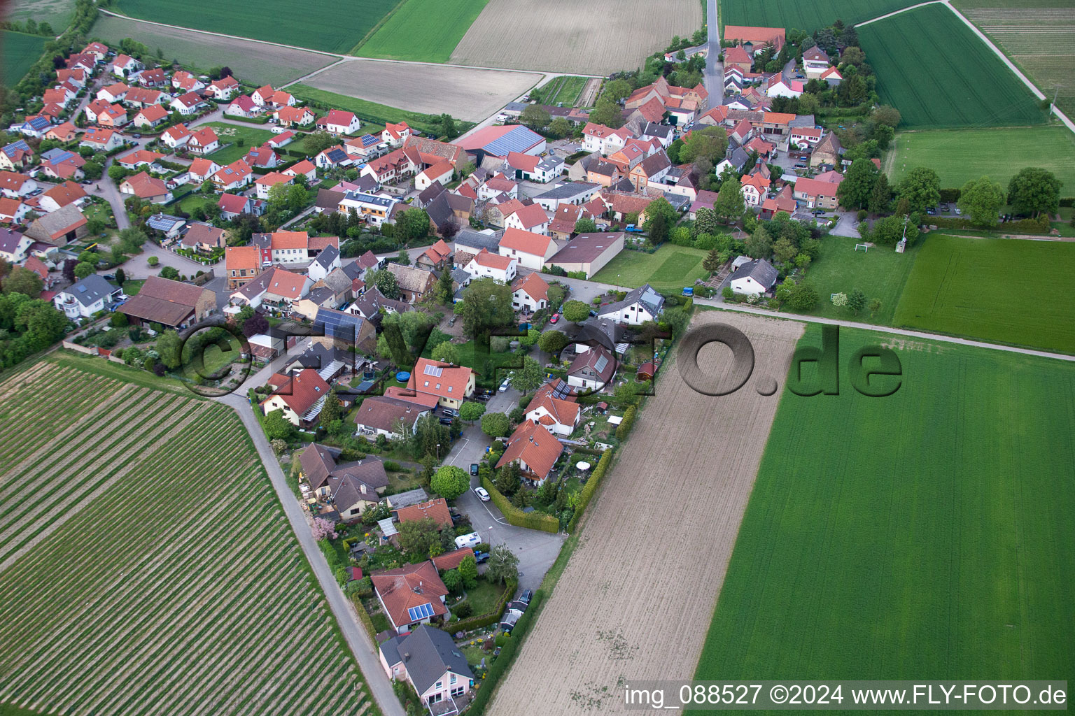 Aerial view of Village - view on the edge of agricultural fields and farmland in Frettenheim in the state Rhineland-Palatinate, Germany