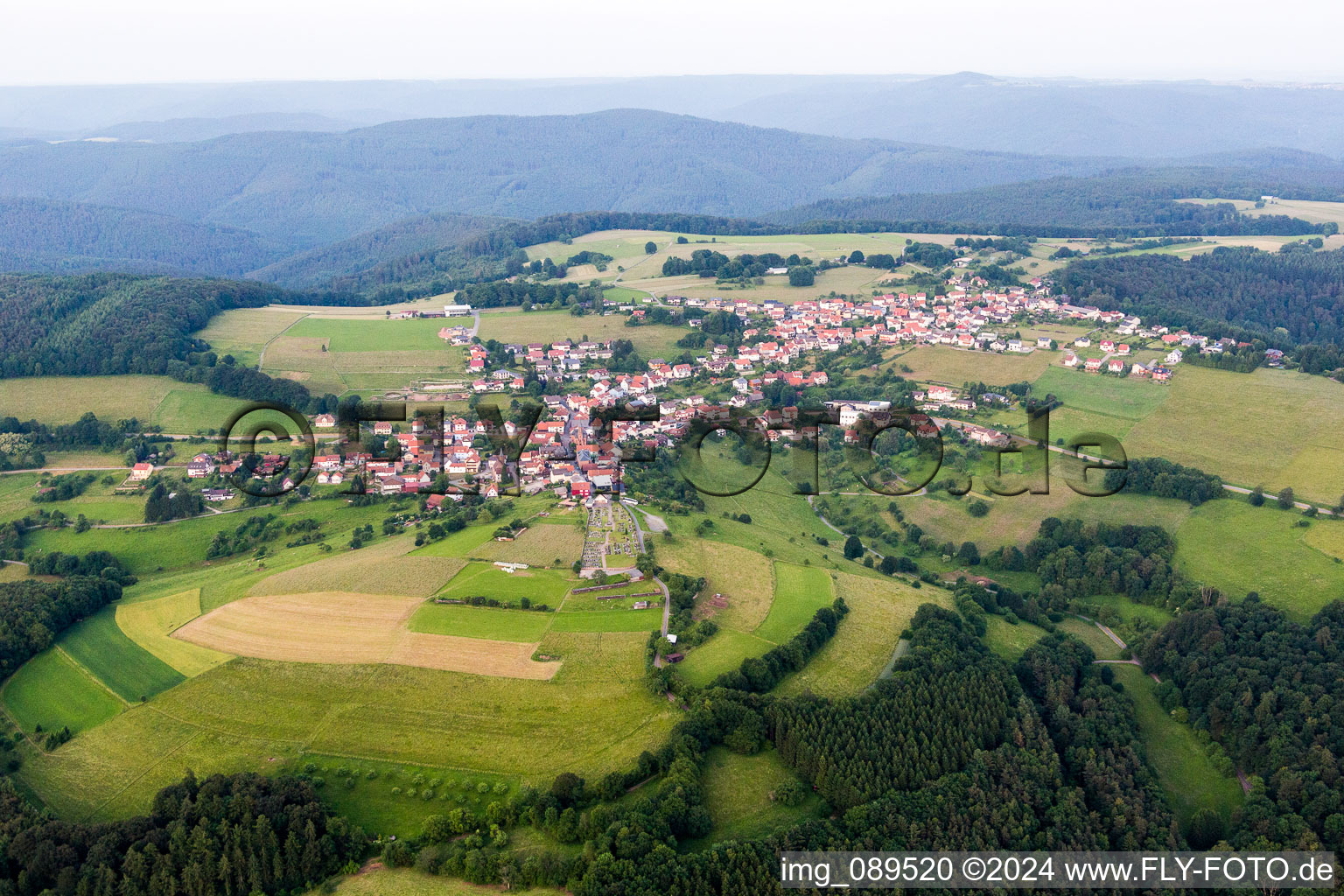 Village - view on the edge of agricultural fields and farmland in Rothenberg in the state Hesse, Germany