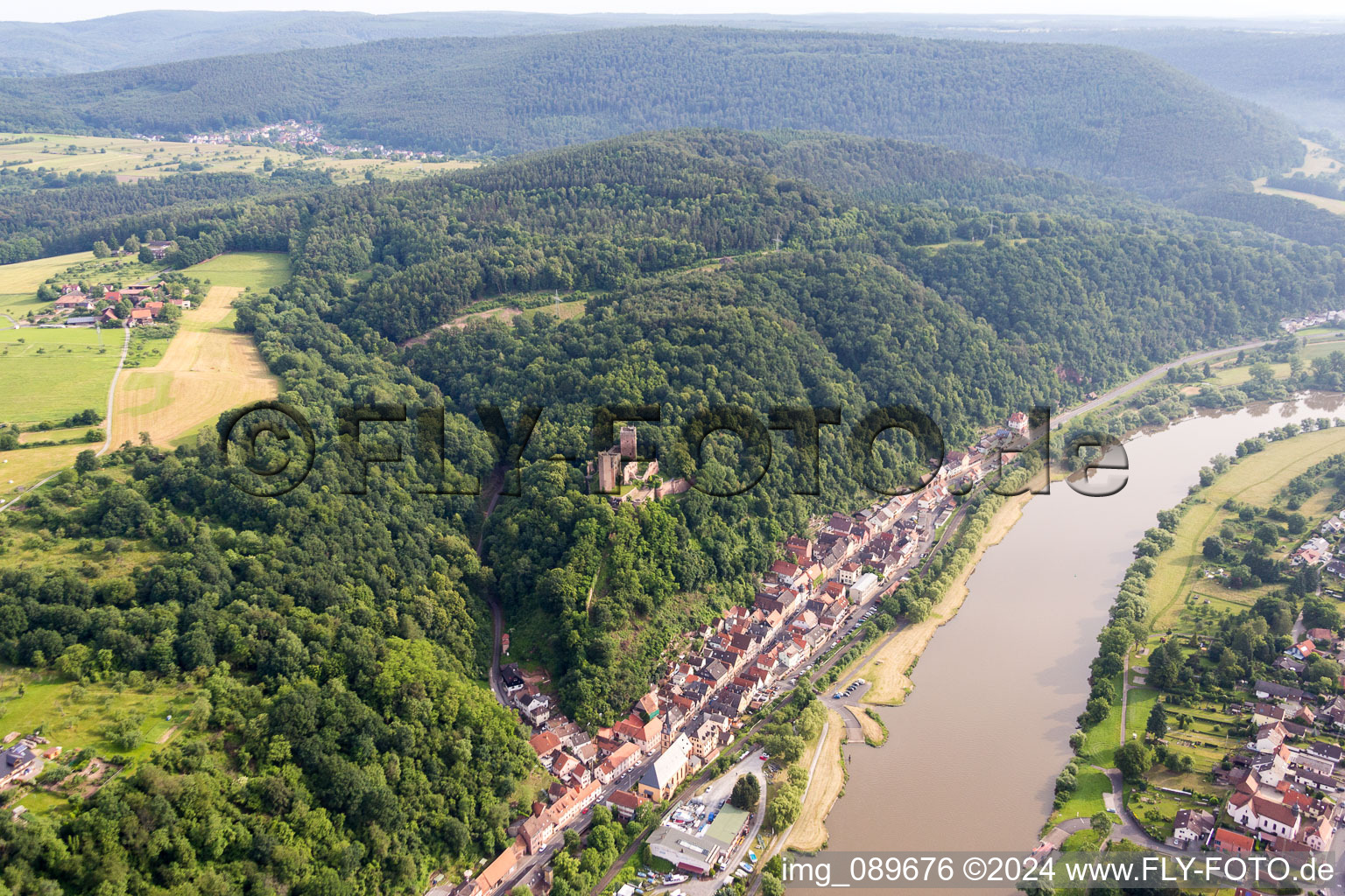 Aerial view of Fortress Henneburg over the Village on the river bank areas of the Main river in Stadtprozelten in the state Bavaria, Germany