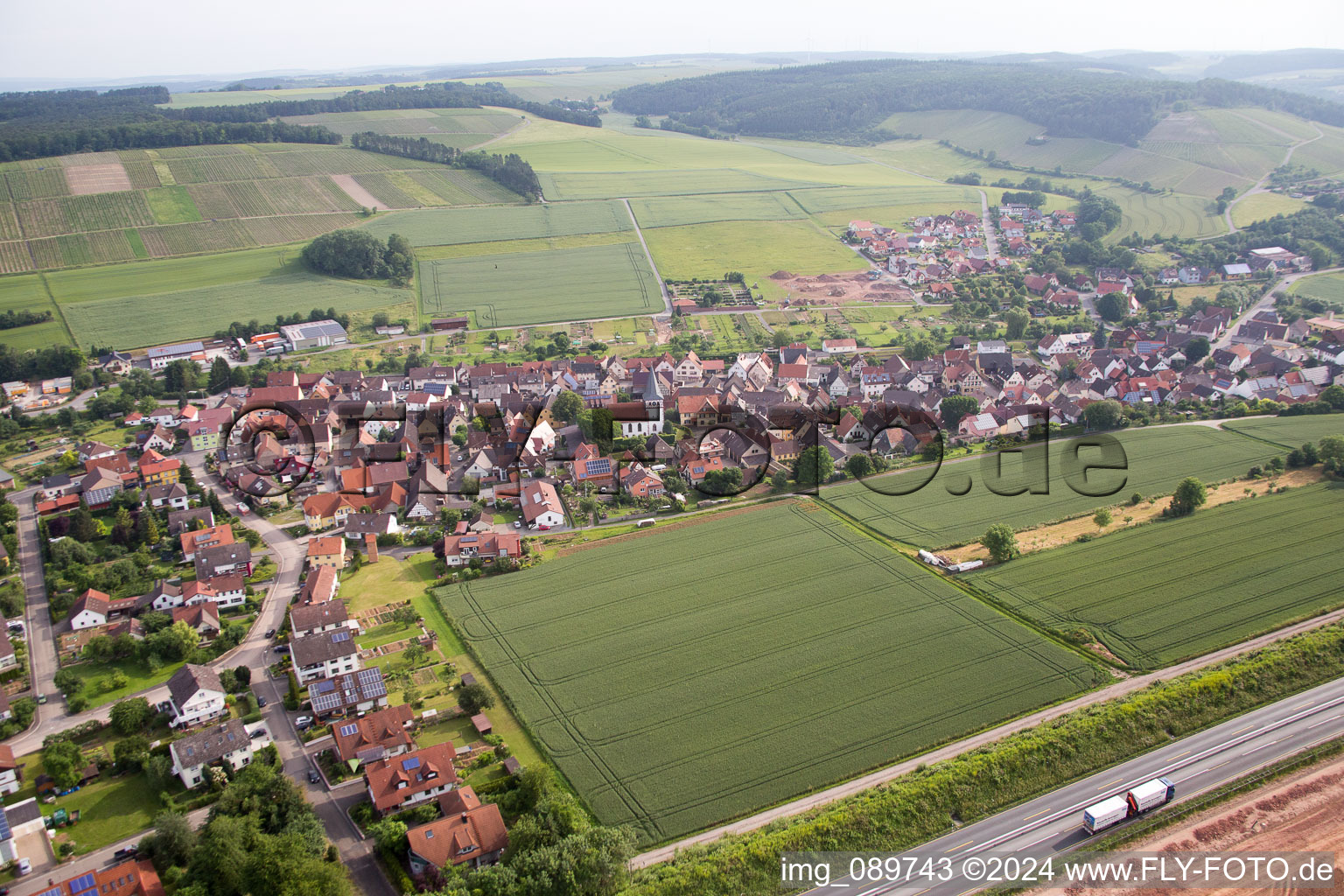 Aerial photograpy of Village - view behind motorway A3 on the edge of agricultural fields and farmland in the district Dertingen in Wertheim in the state Baden-Wurttemberg