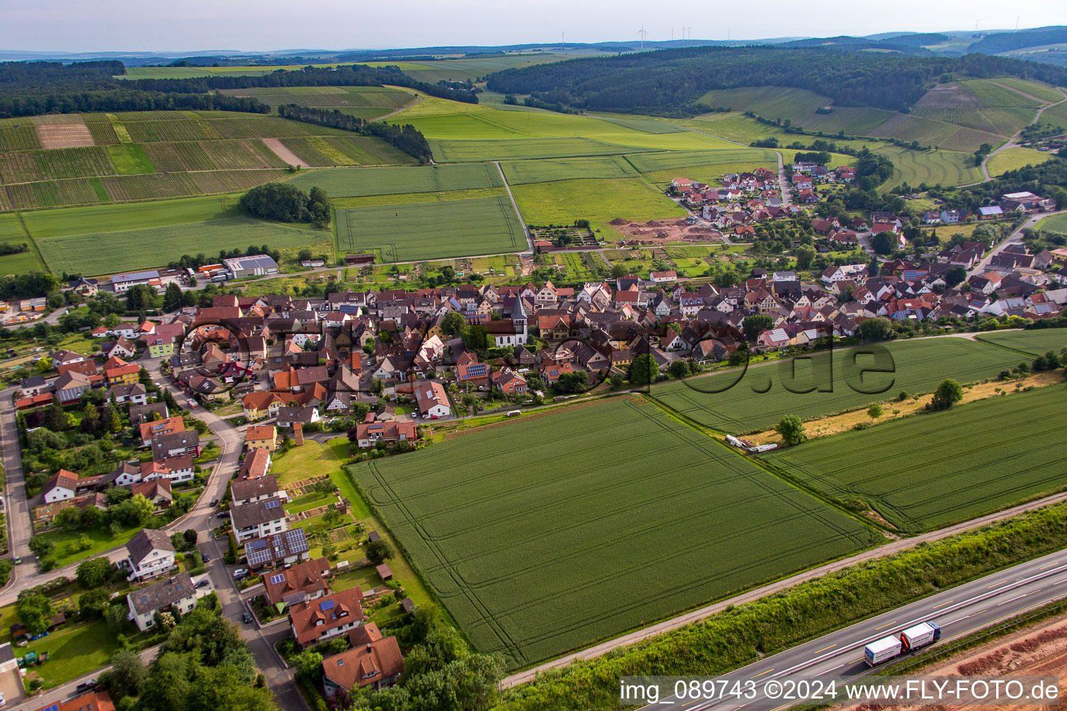 Aerial photograpy of Village - view behind motorway A3 on the edge of agricultural fields and farmland in the district Dertingen in Wertheim in the state Baden-Wurttemberg