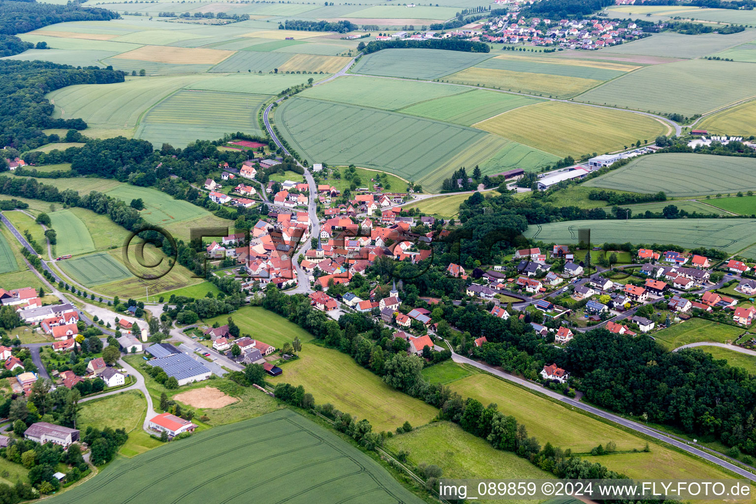 Village - view on the edge of agricultural fields and farmland in the district Rothhausen in Thundorf in Unterfranken in the state Bavaria, Germany