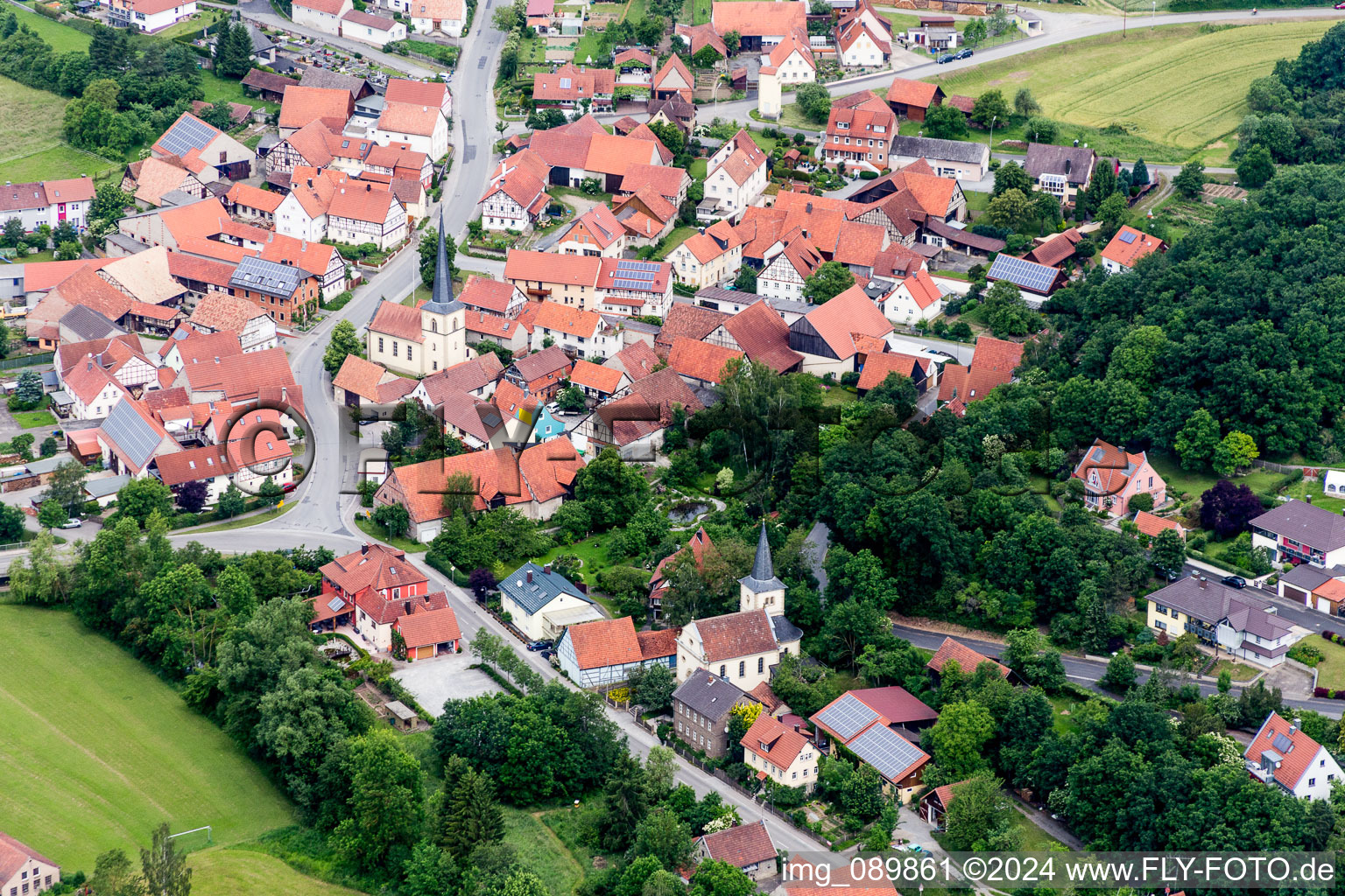 Aerial view of Village - view on the edge of agricultural fields and farmland in the district Rothhausen in Thundorf in Unterfranken in the state Bavaria, Germany