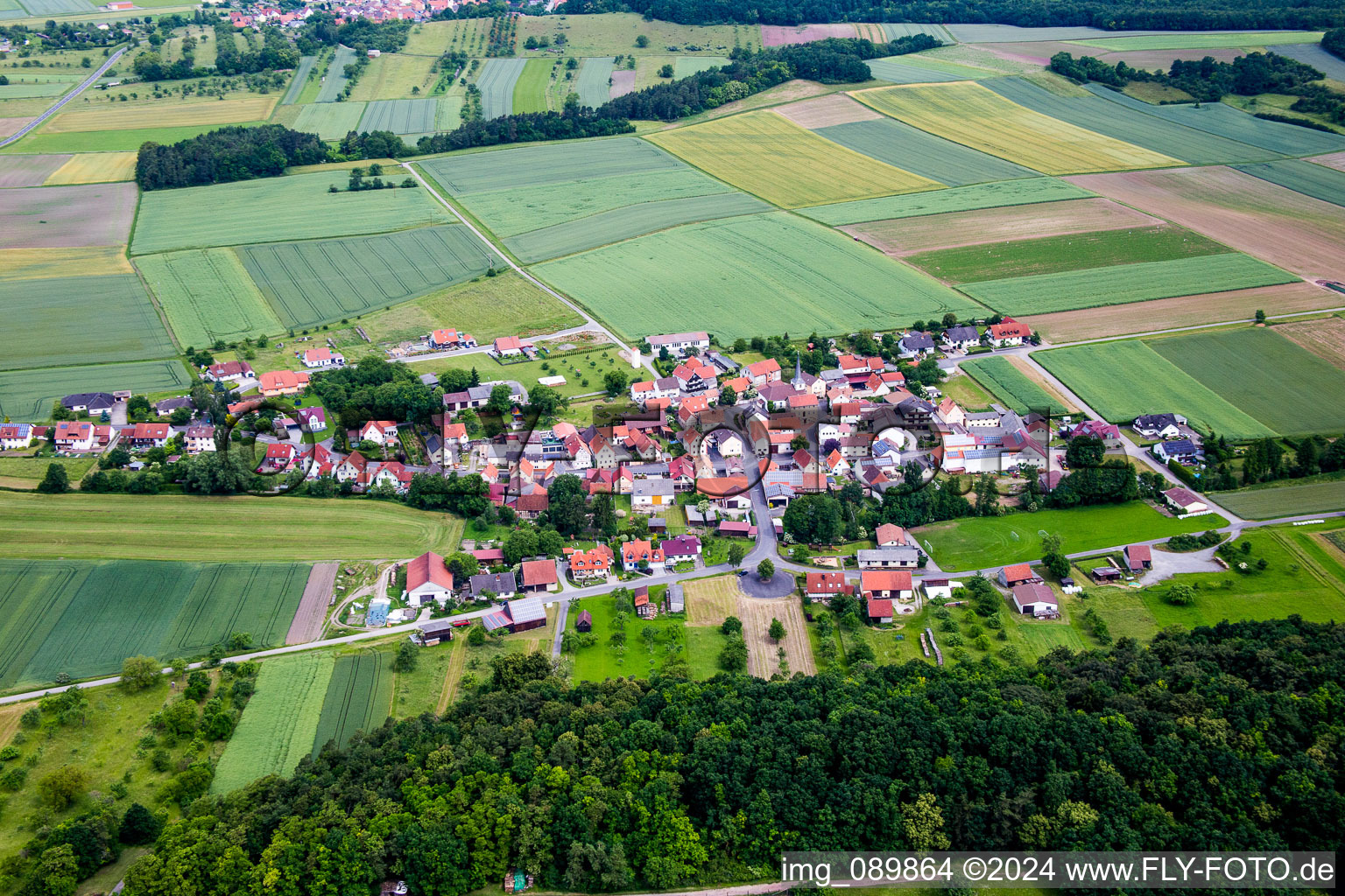 Village - view on the edge of agricultural fields and farmland in Theinfeld in the state Bavaria, Germany