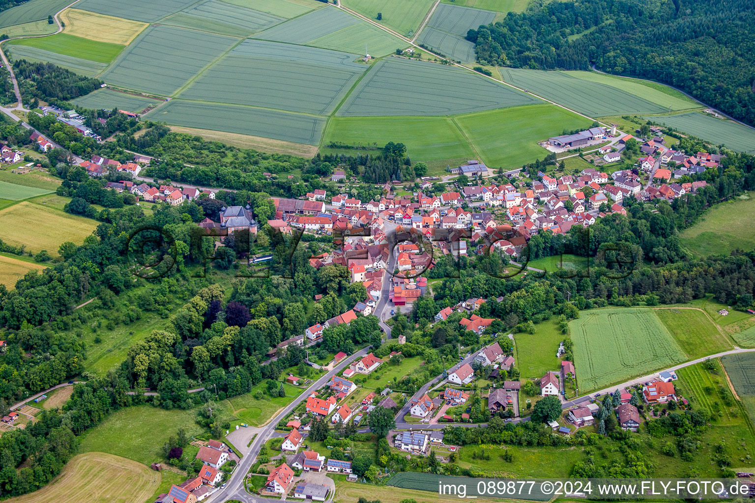 Village - view on the edge of agricultural fields and farmland in Waltershausen in the state Bavaria, Germany