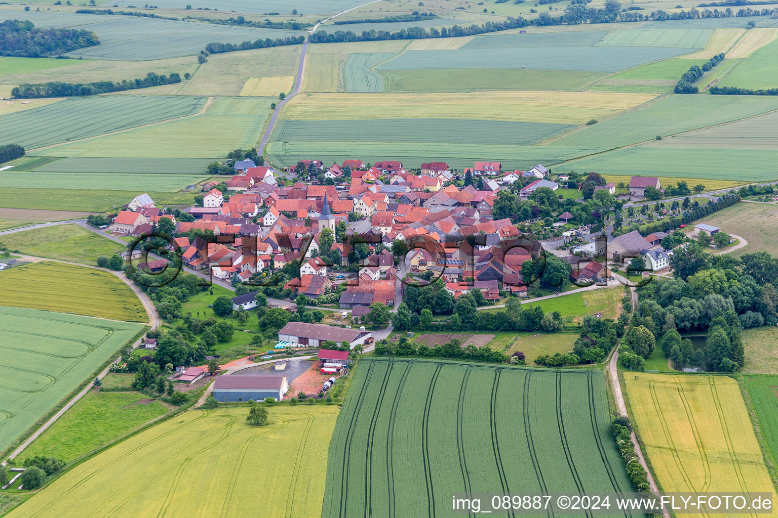 Village - view on the edge of agricultural fields and farmland in the district Rothausen in Hoechheim in the state Bavaria, Germany
