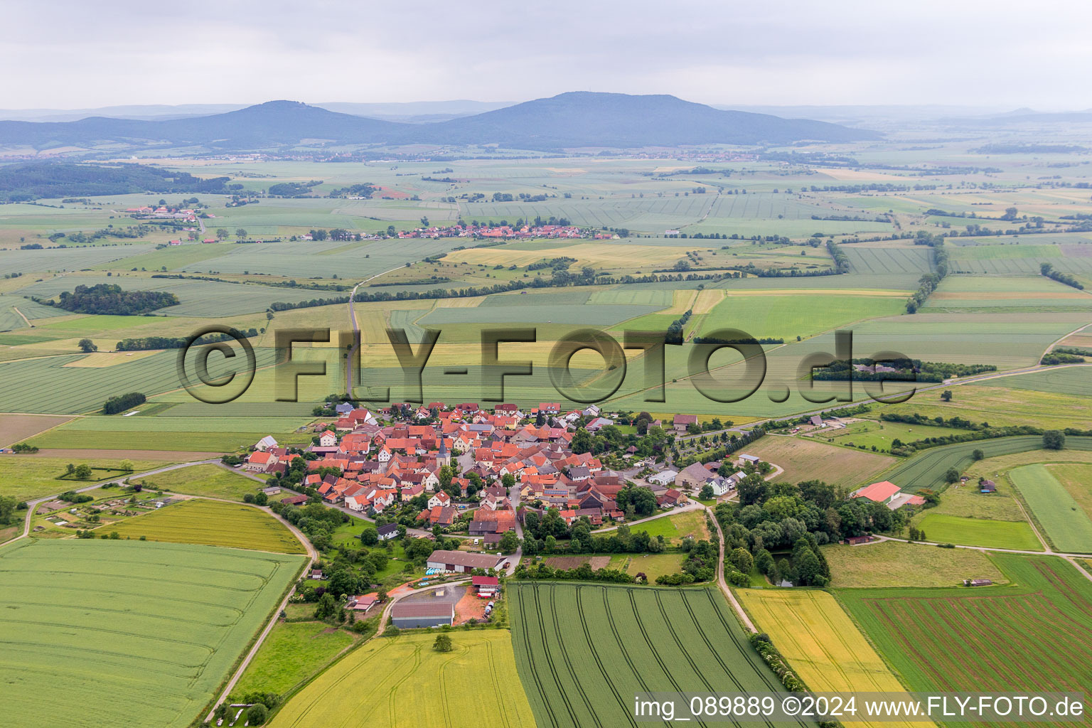 Aerial view of Village - view on the edge of agricultural fields and farmland in the district Rothausen in Hoechheim in the state Bavaria, Germany
