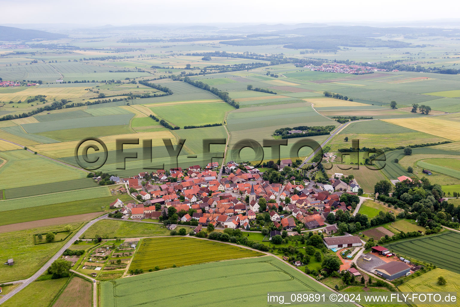 Aerial photograpy of Village - view on the edge of agricultural fields and farmland in the district Rothausen in Hoechheim in the state Bavaria, Germany