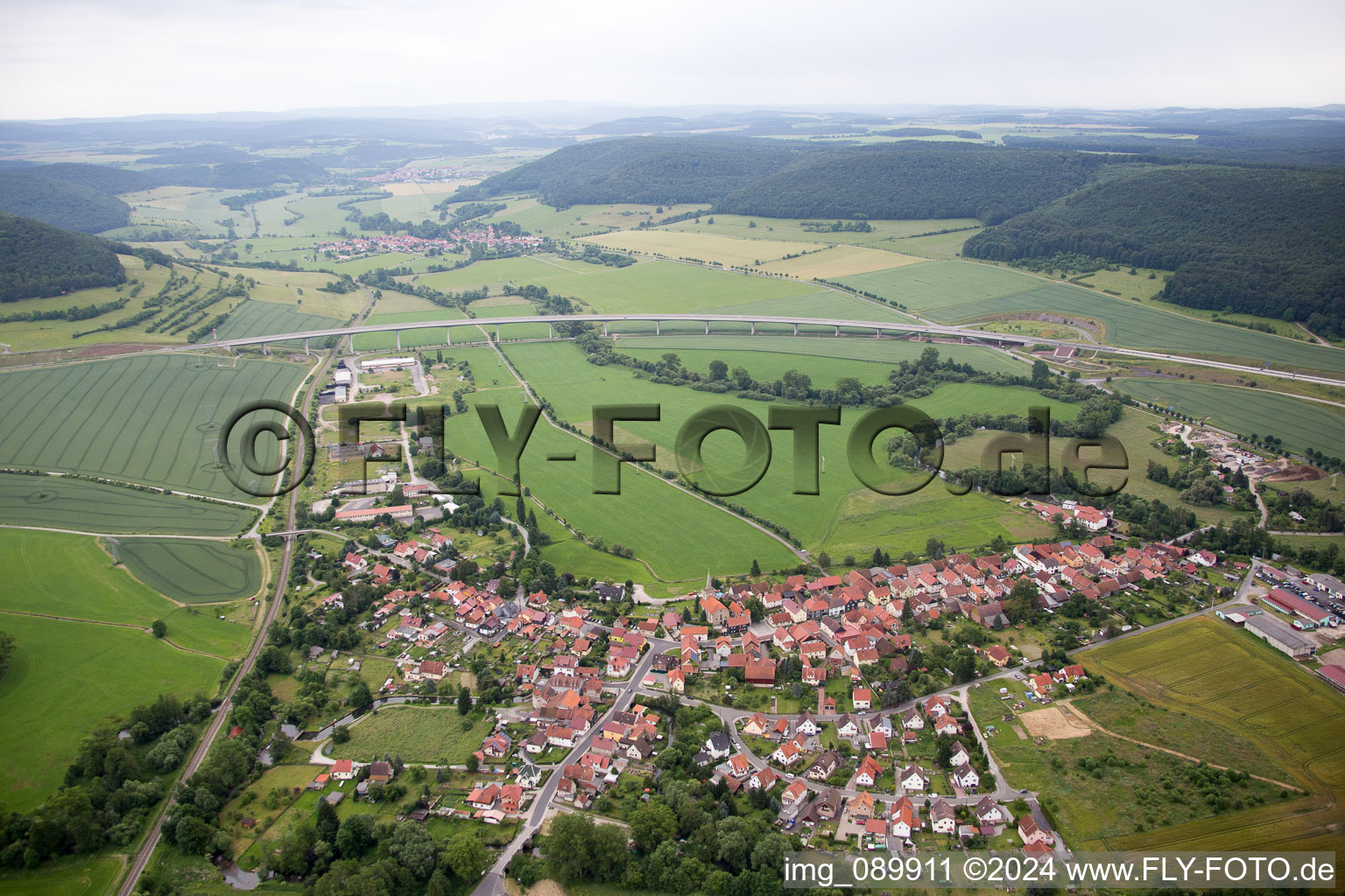 Aerial view of Village - view on the edge of agricultural fields and farmland in Einhausen in the state Thuringia, Germany