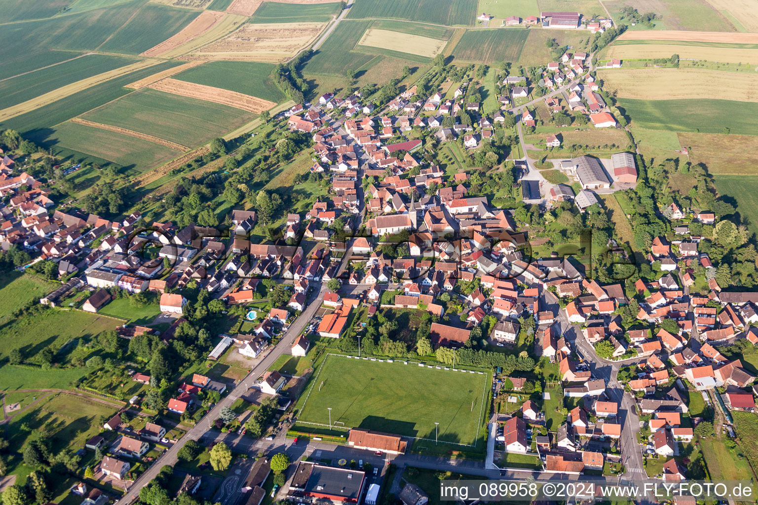 Aerial view of Village - view on the edge of agricultural fields and farmland in Riedseltz in Grand Est, France