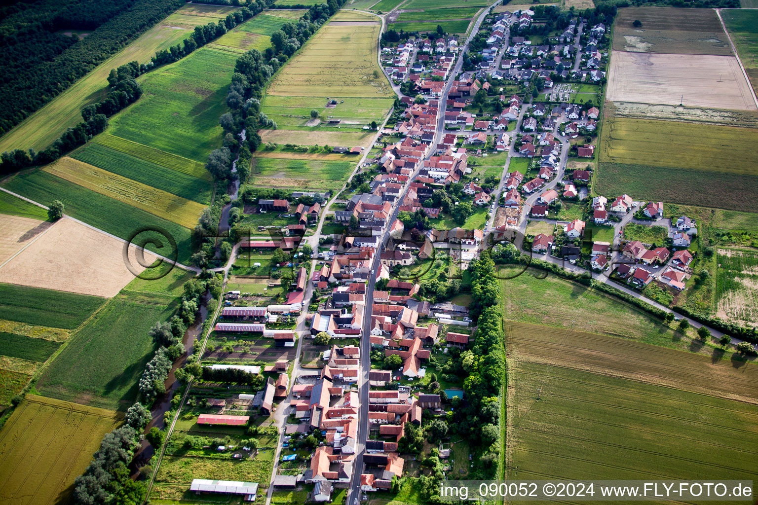 Village - view on the edge of agricultural fields and farmland in Herxheimweyher in the state Rhineland-Palatinate, Germany