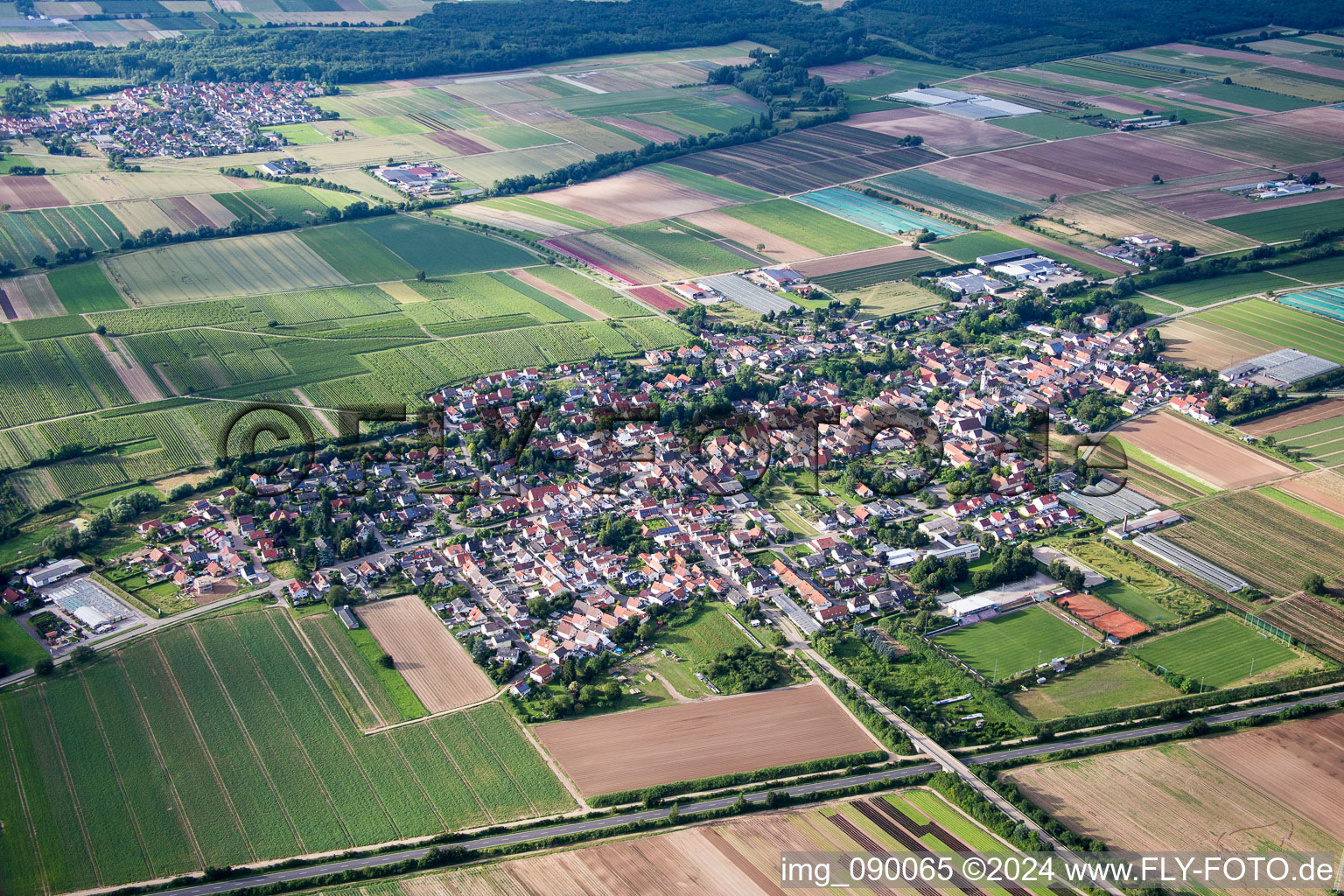 Village - view on the edge of agricultural fields and farmland in Weingarten (Pfalz) in the state Rhineland-Palatinate, Germany