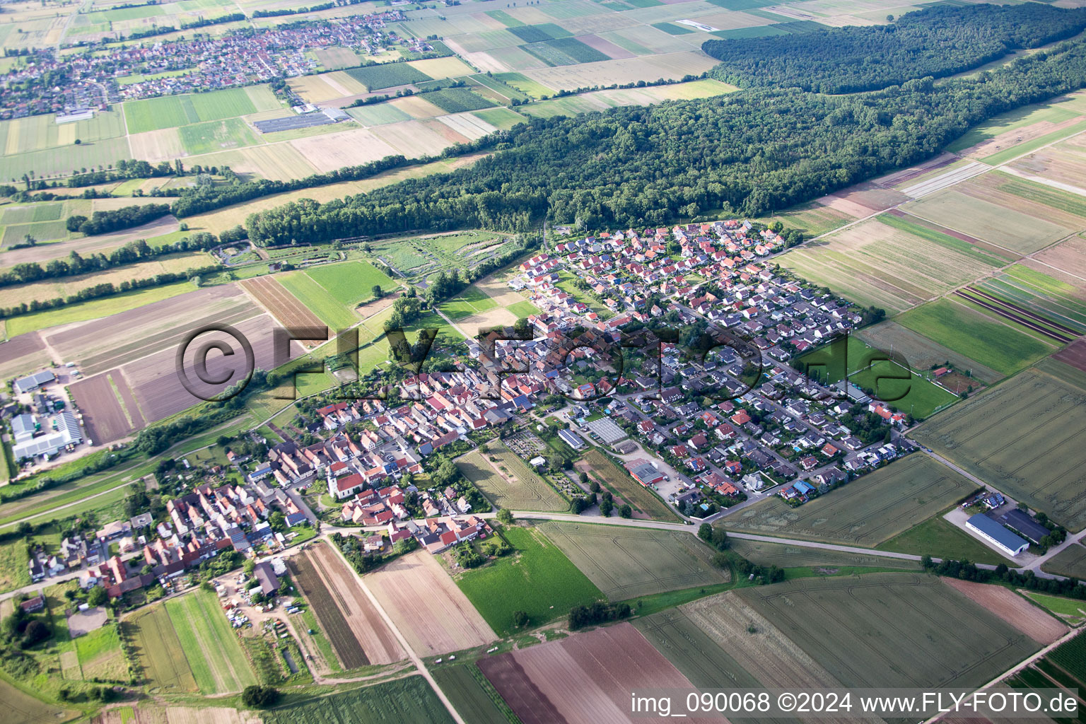Village - view on the edge of agricultural fields and farmland in Freisbach in the state Rhineland-Palatinate, Germany