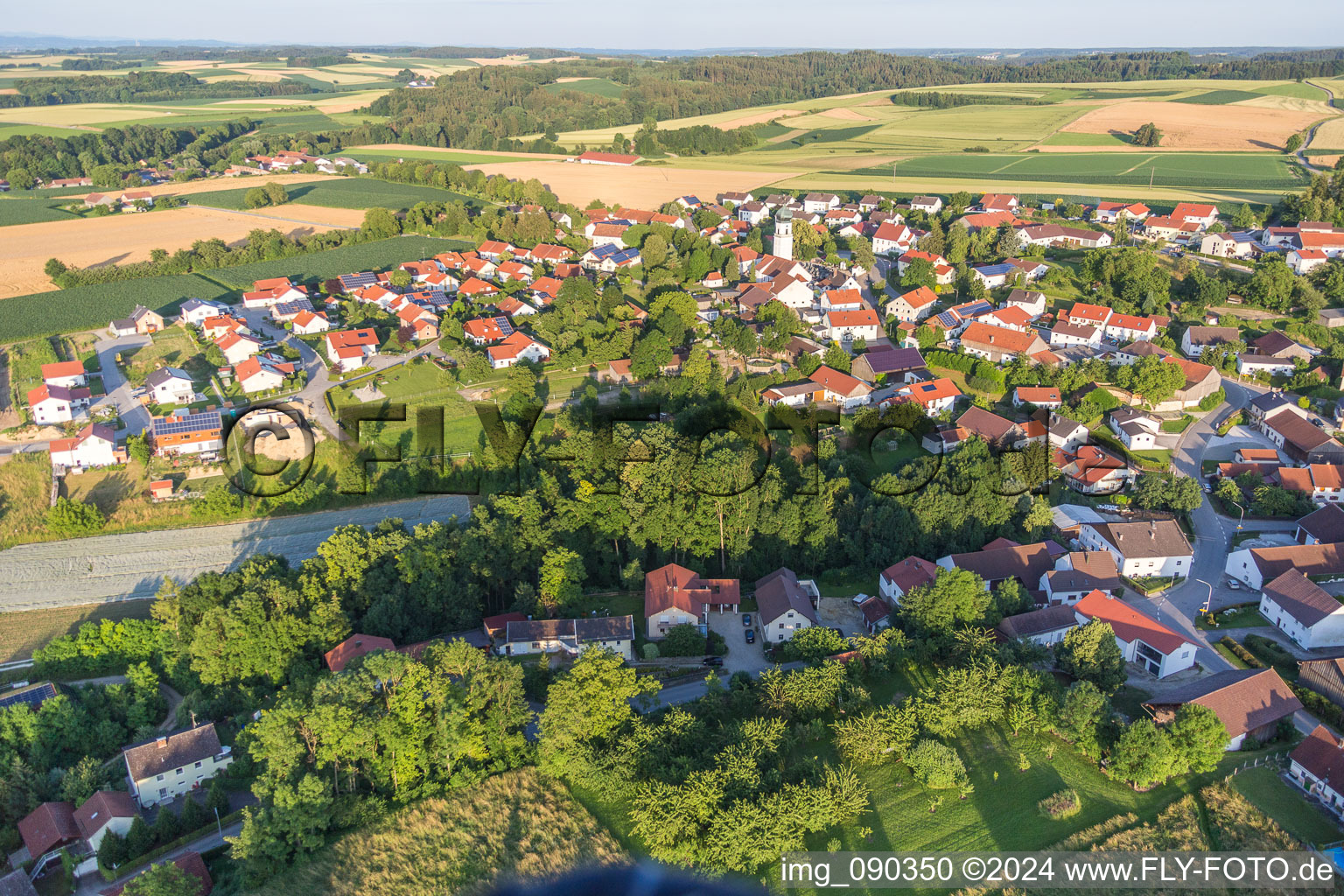 Village - view on the edge of agricultural fields and farmland in Zeholfing in the state Bavaria, Germany