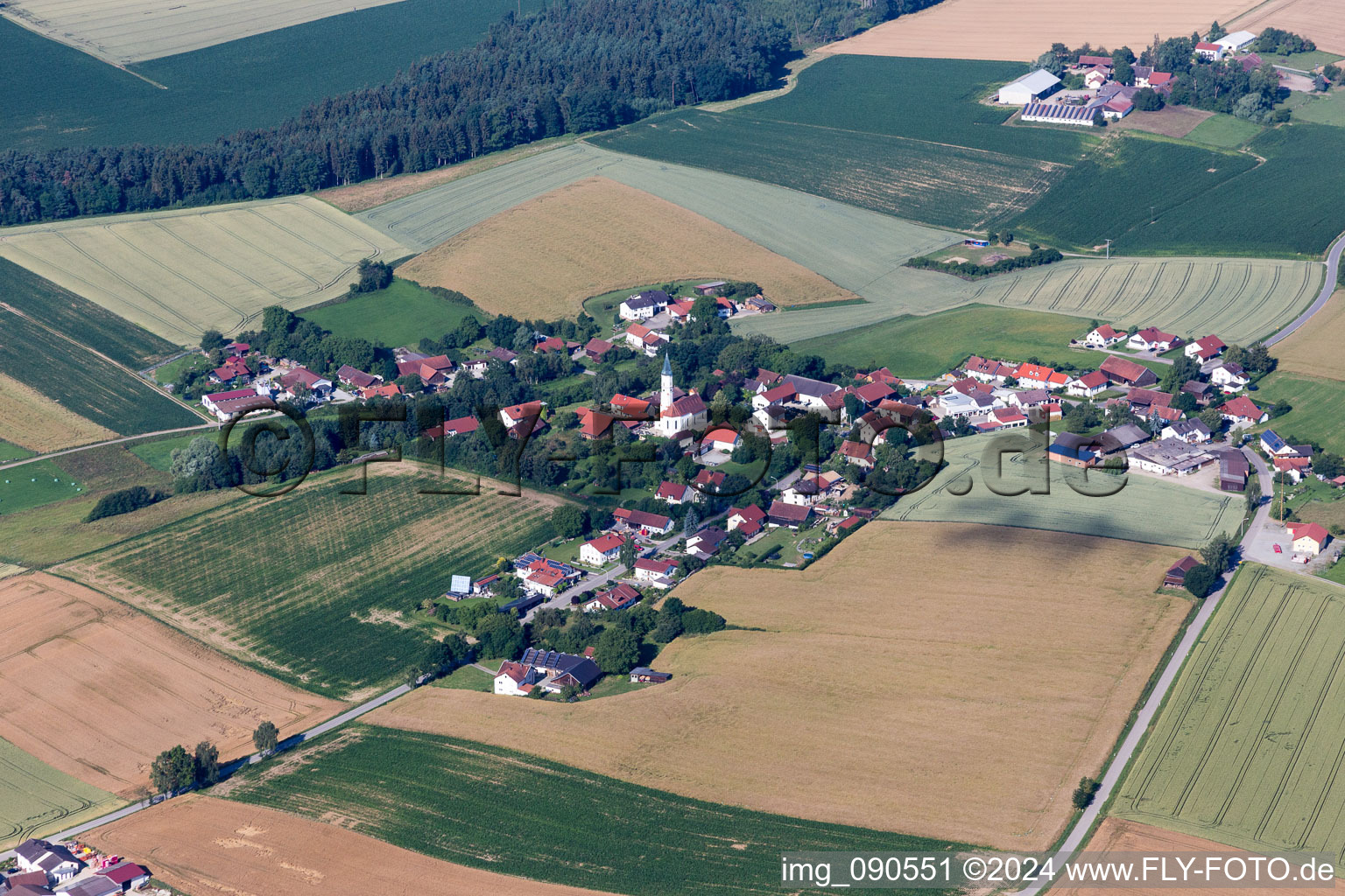 Village - view on the edge of agricultural fields and farmland in the district Hagenau in Mengkofen in the state Bavaria, Germany