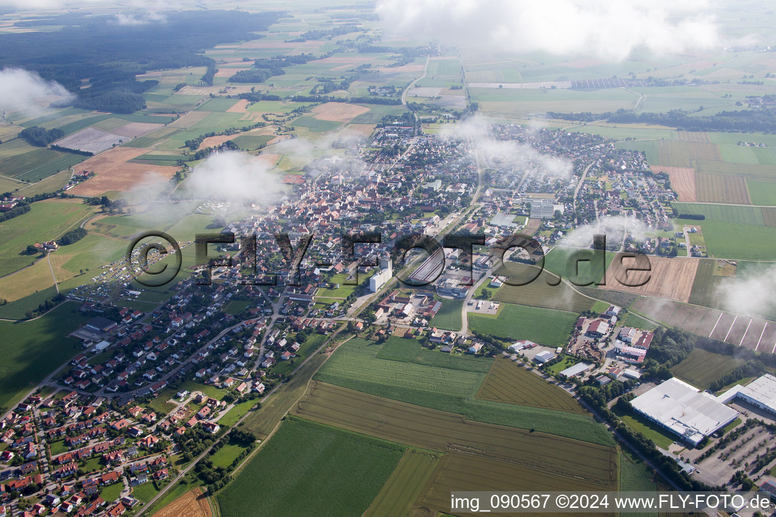 Oblique view of Town View of the streets and houses below clouds of the residential areas in Geiselhoering in the state Bavaria