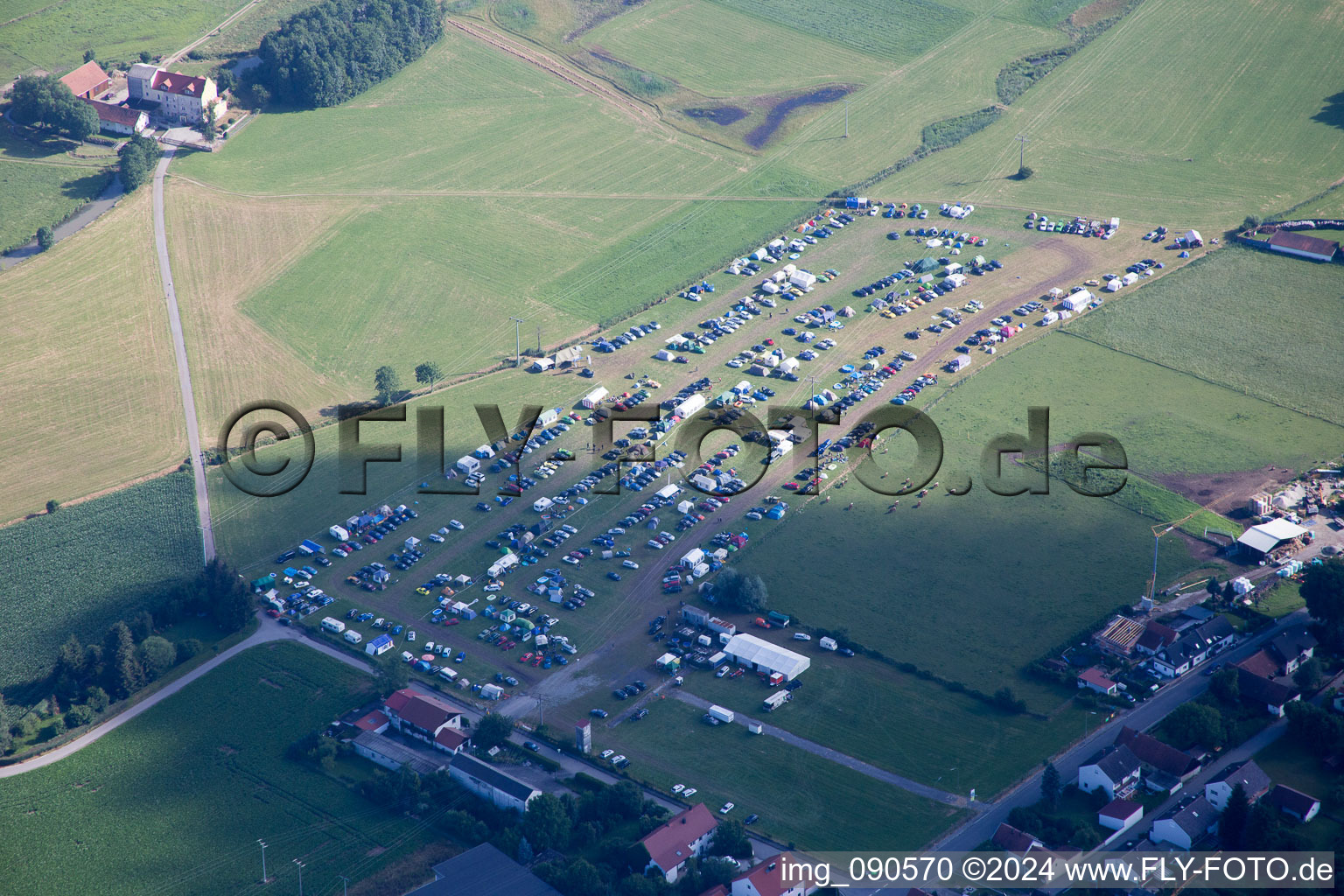 Camping with caravans and tents on a field in Geiselhoering in the state Bavaria