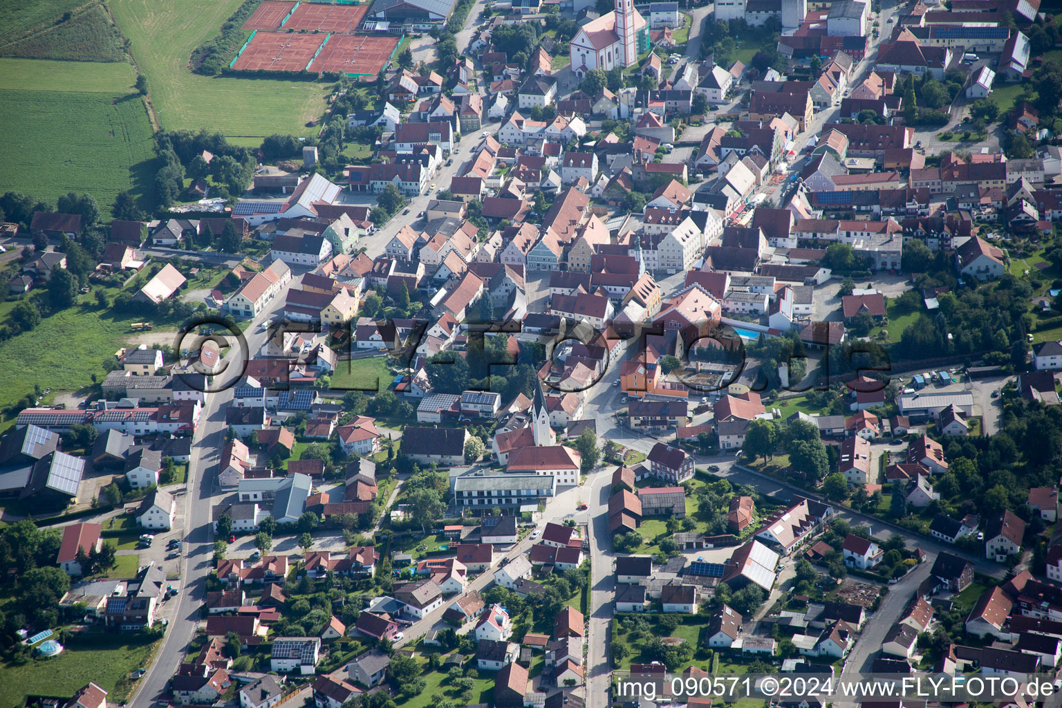 Town View of the streets and houses below clouds of the residential areas in Geiselhoering in the state Bavaria from above