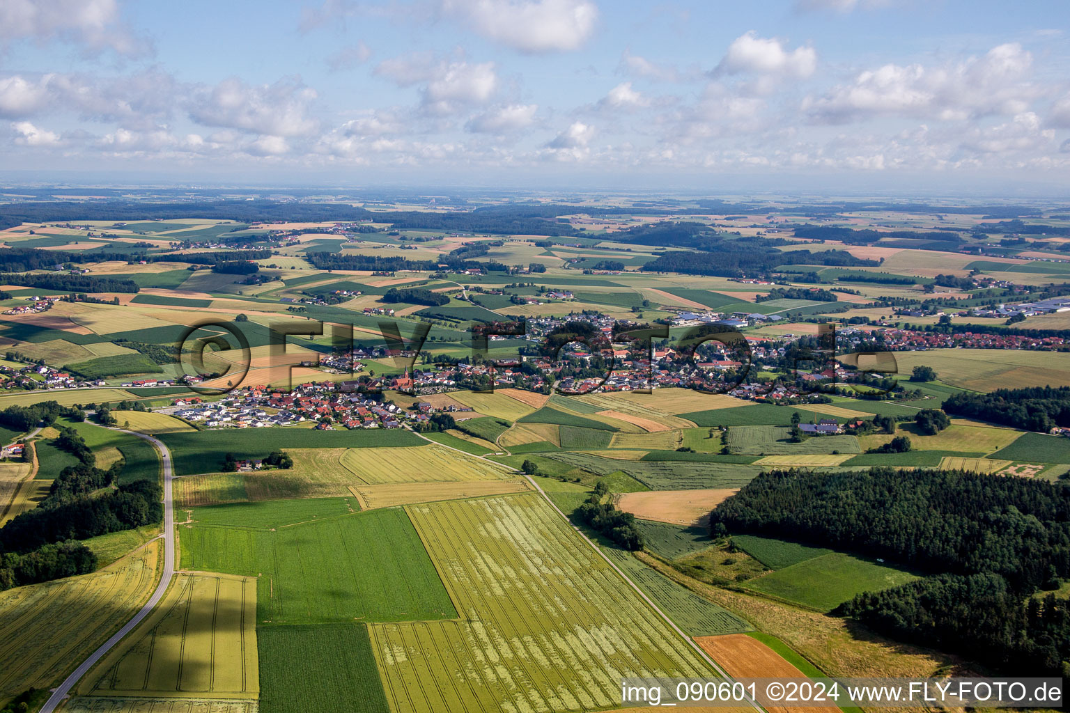 Aerial view of Village - view on the edge of agricultural fields and farmland in Mengkofen in the state Bavaria, Germany