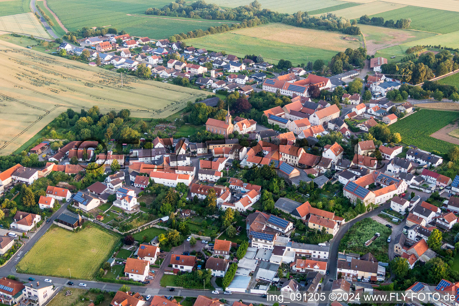 Aerial view of Village - view on the edge of agricultural fields and farmland in Lautersheim in the state Rhineland-Palatinate, Germany