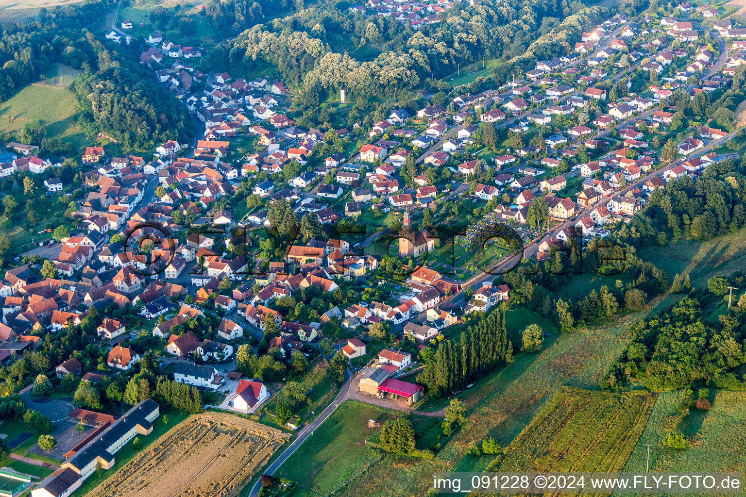 Village - view on the edge of agricultural fields and farmland in Sippersfeld in the state Rhineland-Palatinate, Germany